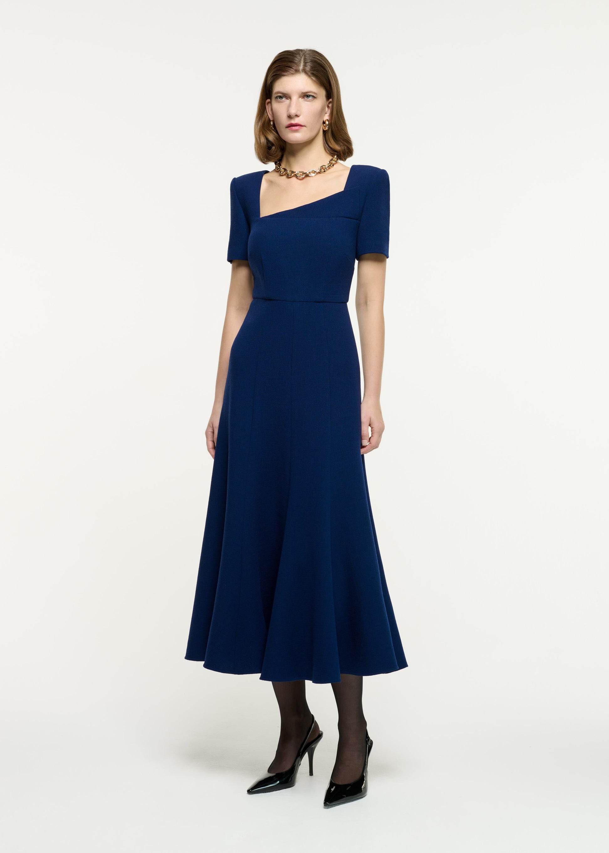 Side view of a model wearing the Short Sleeve Wool Crepe Midi Dress in Blue