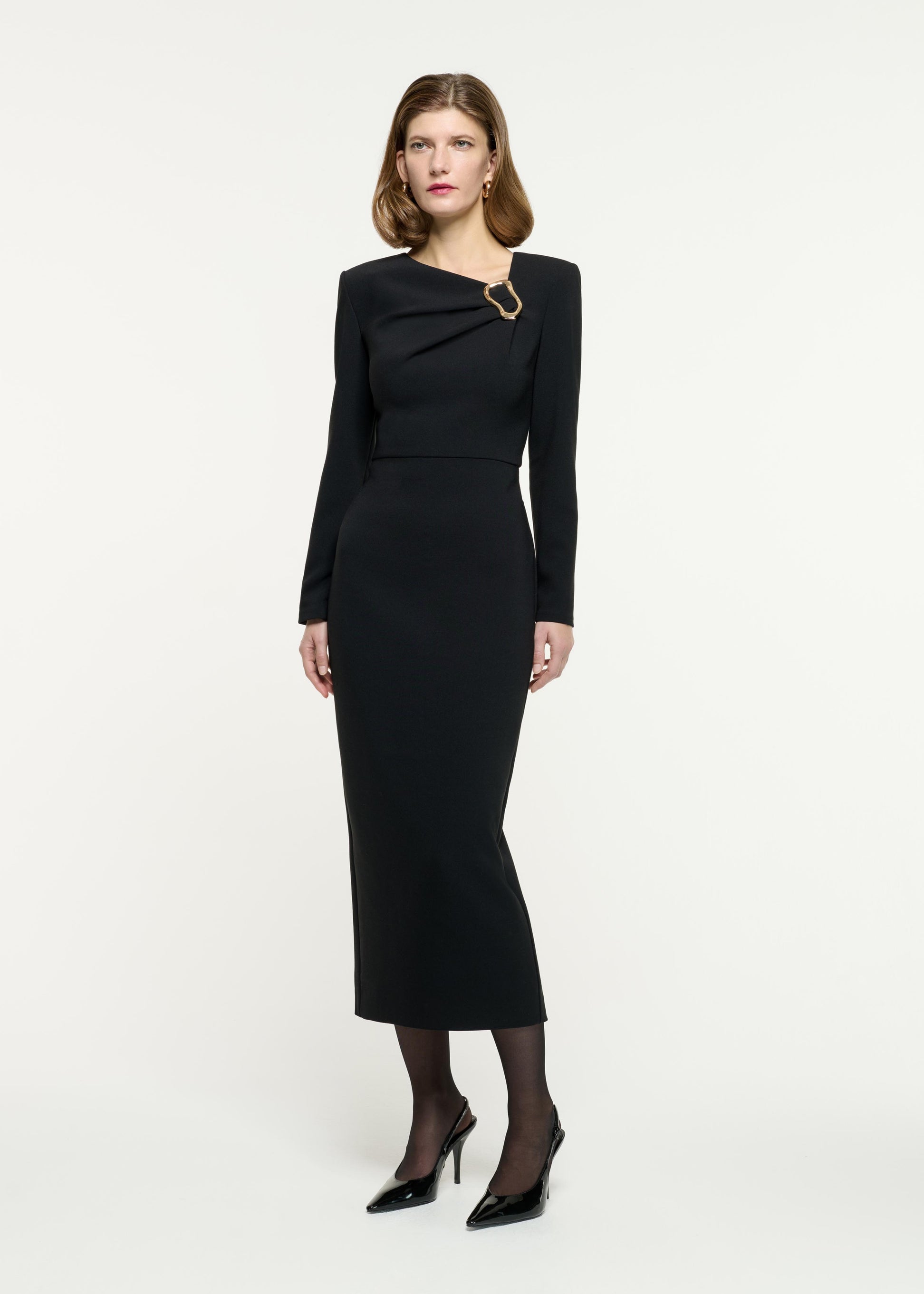 Side view of a model wearing the Long Sleeve Buckle Crepe Midi Dress in Black