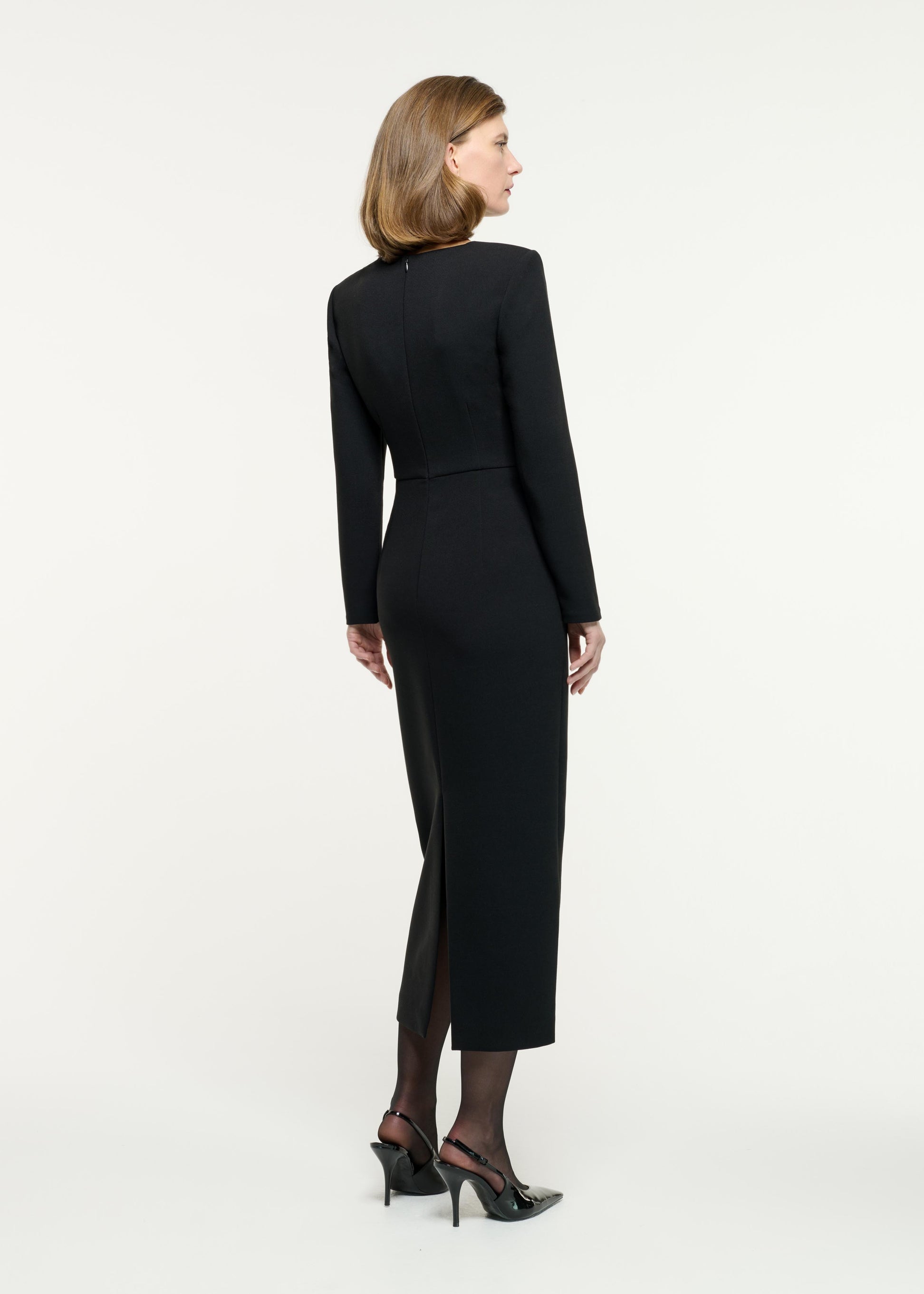 Back view of a model wearing the Long Sleeve Buckle Crepe Midi Dress in Black