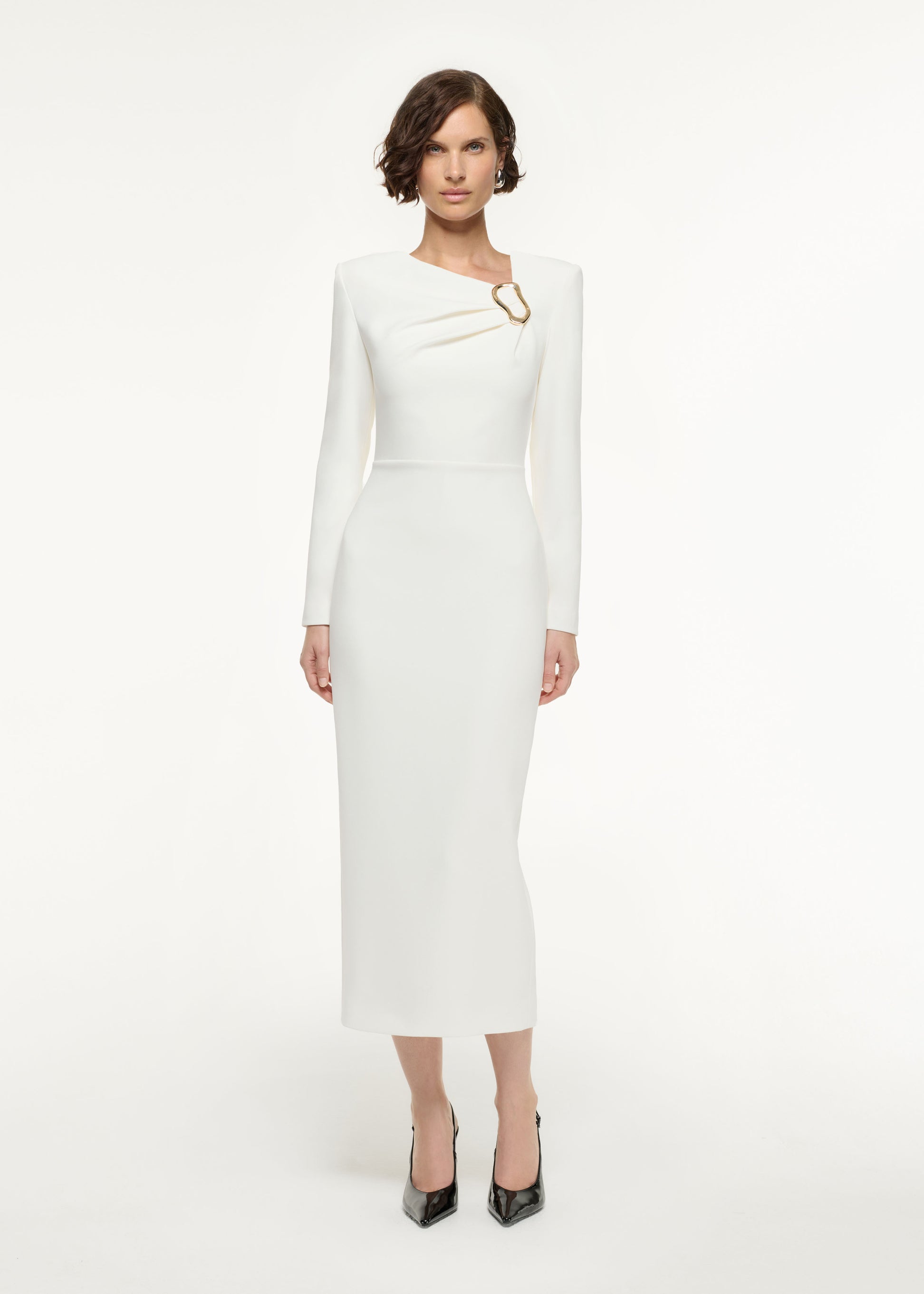 Front view of a model wearing the Long Sleeve Buckle Crepe Midi Dress in Cream