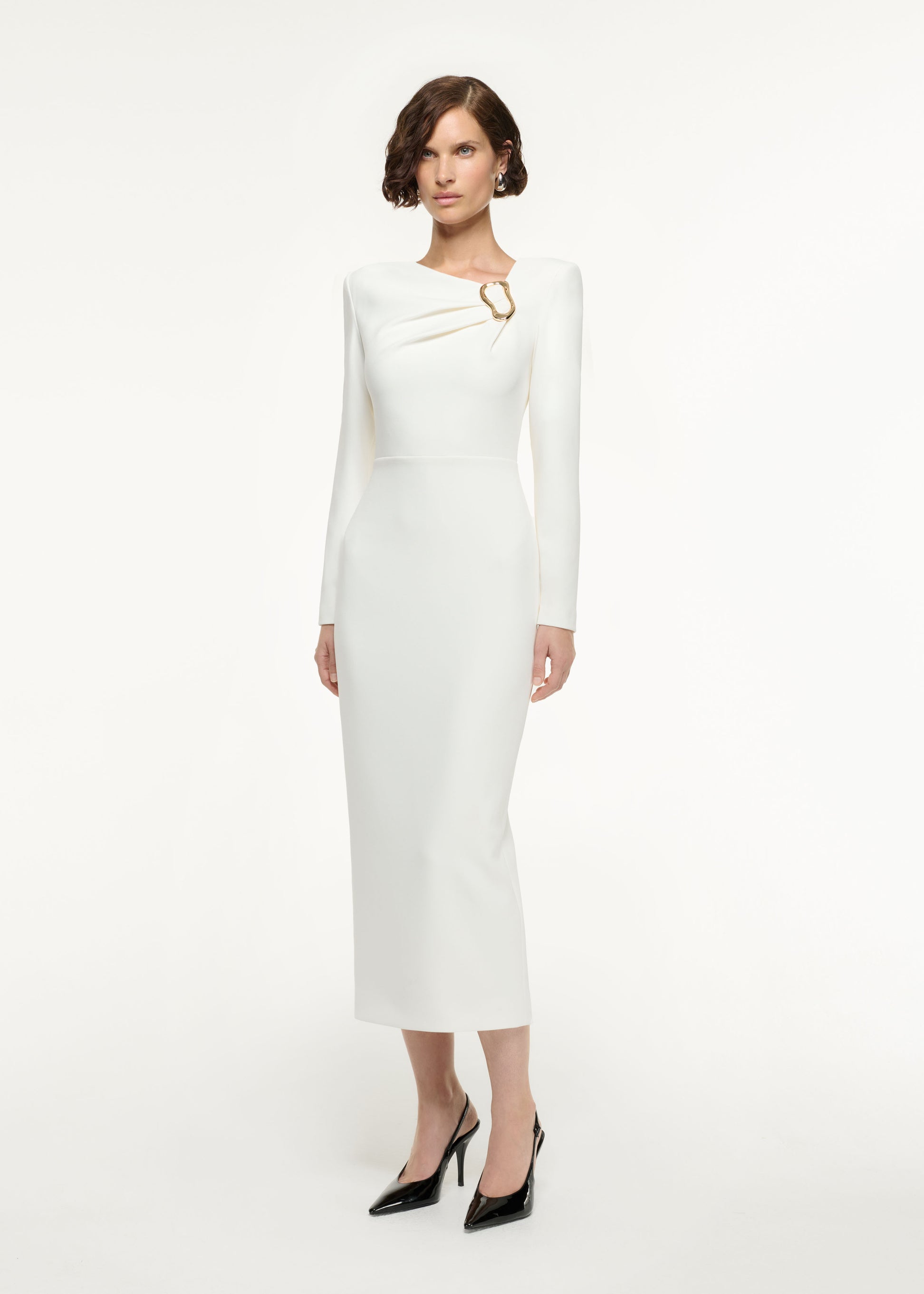 Side view of a model wearing the Long Sleeve Buckle Crepe Midi Dress in Cream