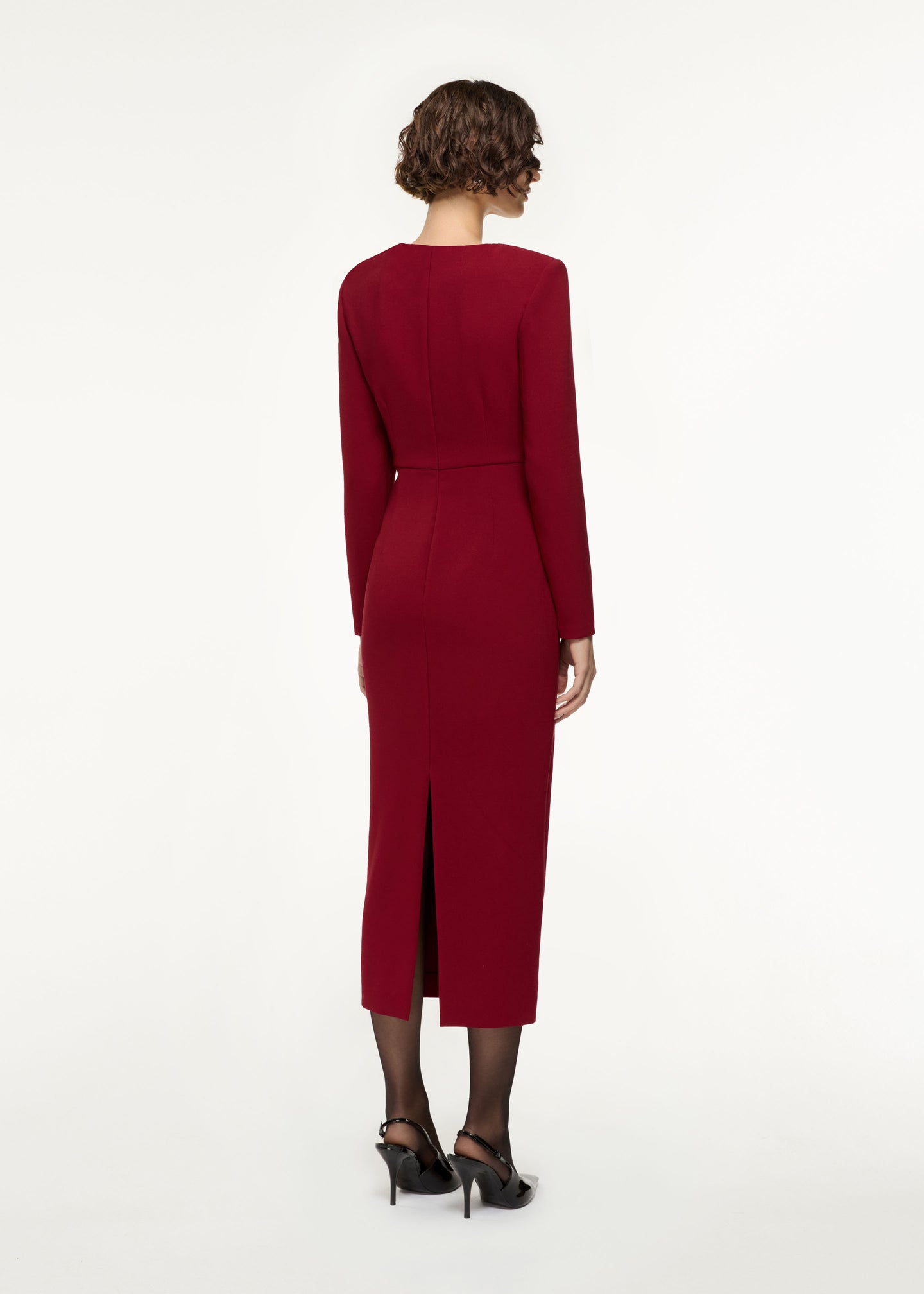 Back view of a model wearing the Long Sleeve Buckle Crepe Midi Dress in Red
