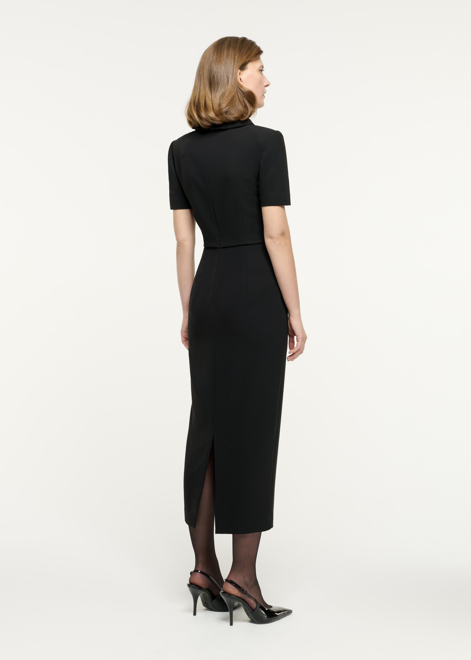 Back view of a model wearing the Collared Midi Dress in Black