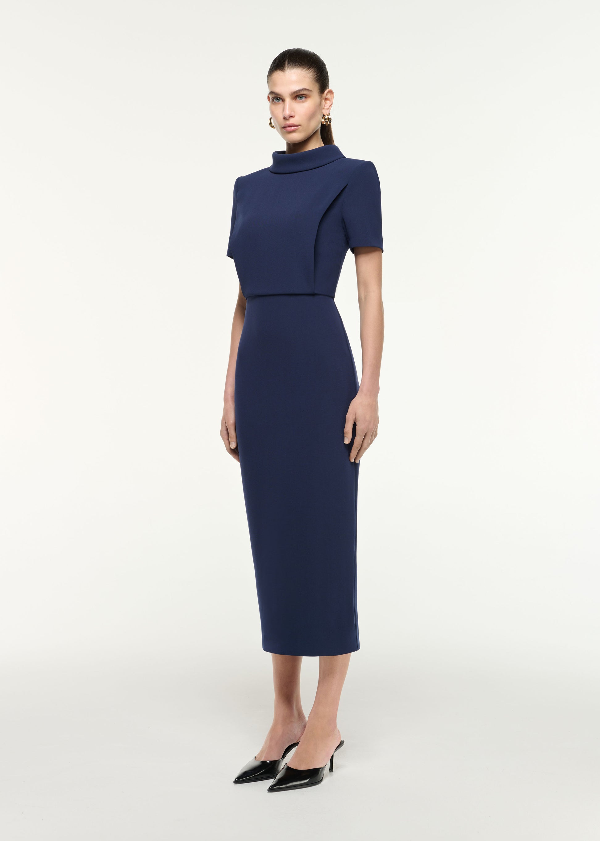 Side view of a model wearing the Collared Midi Dress in Navy