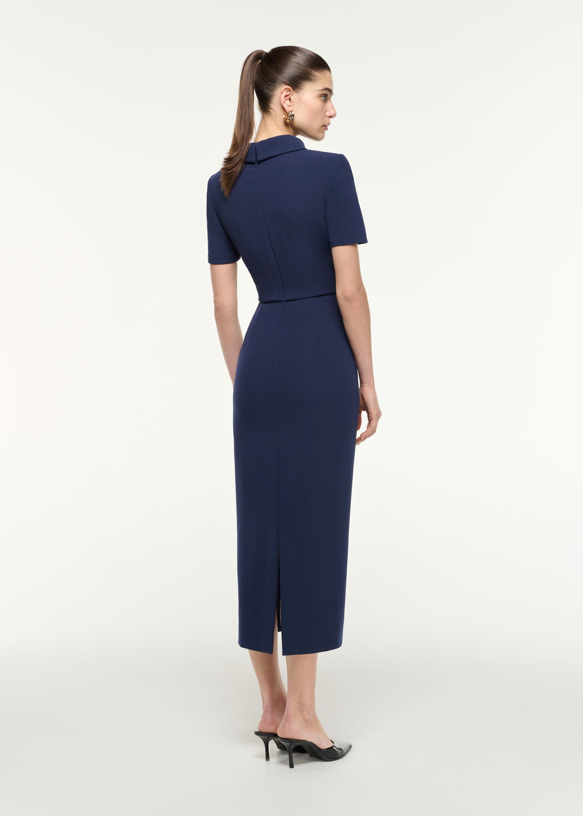 Back view of a model wearing the Collared Midi Dress in Navy
