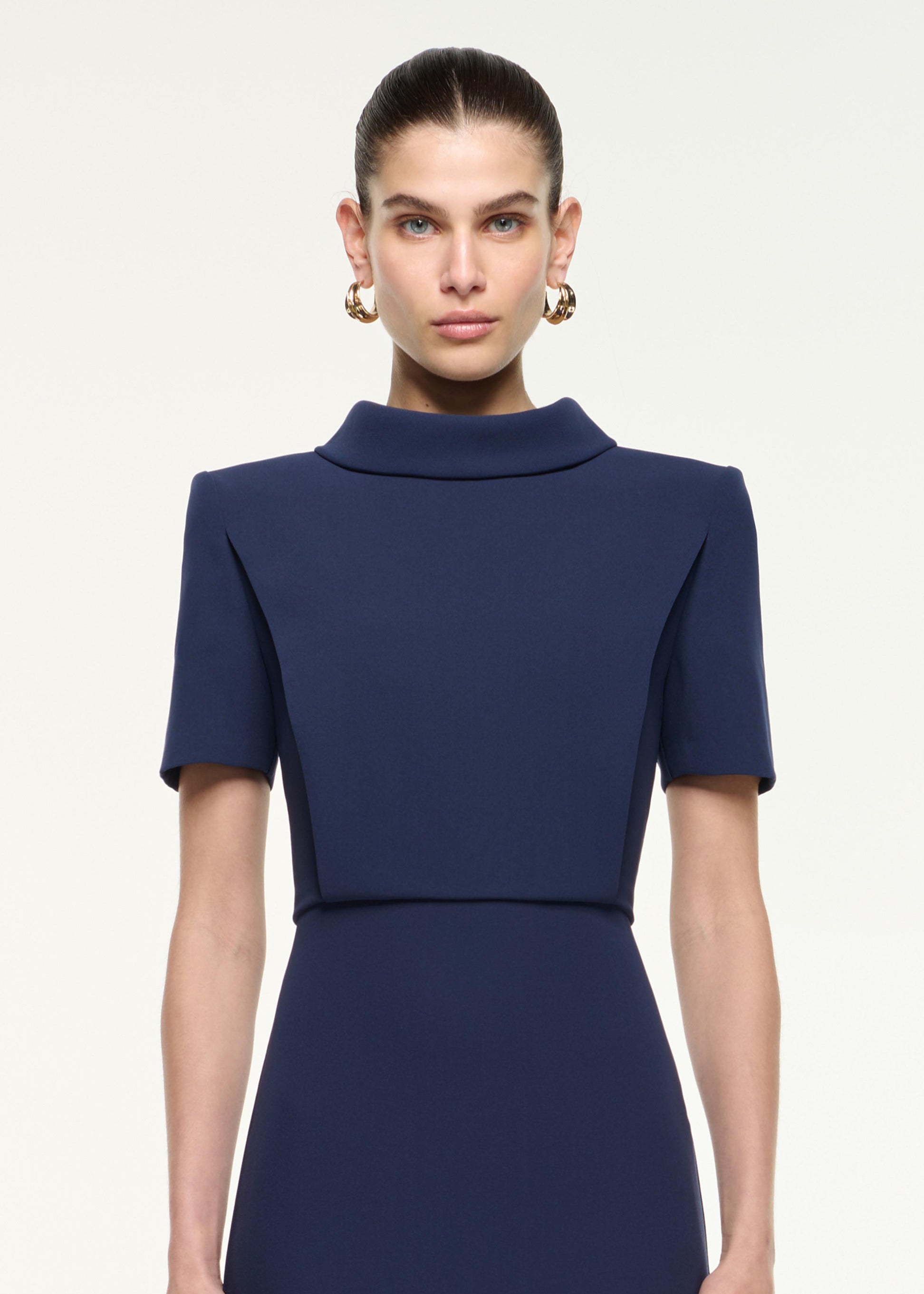 Close up of a model wearing the Collared Midi Dress in Navy