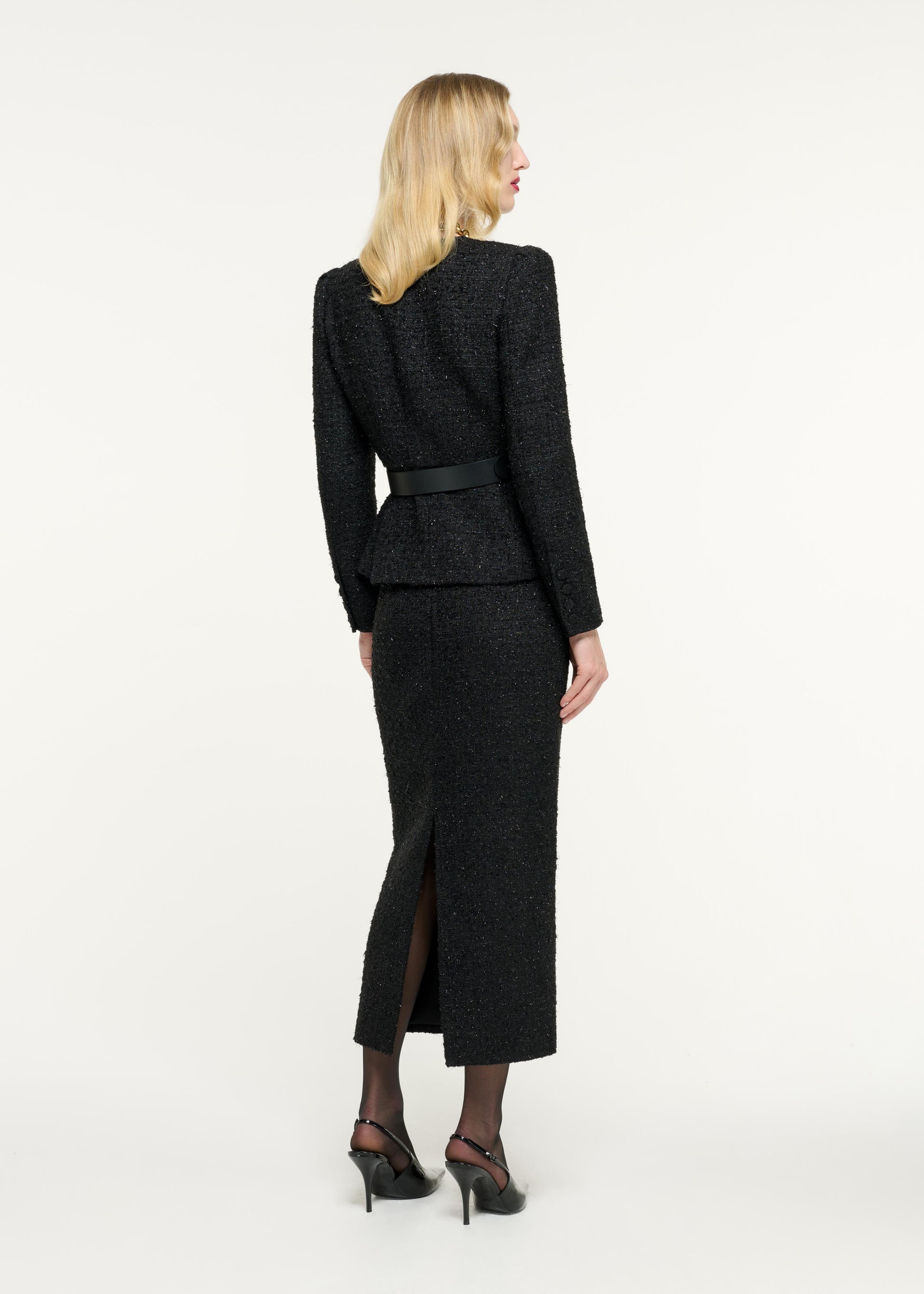 Back view of a model wearing the Boucle Midi Skirt in Black