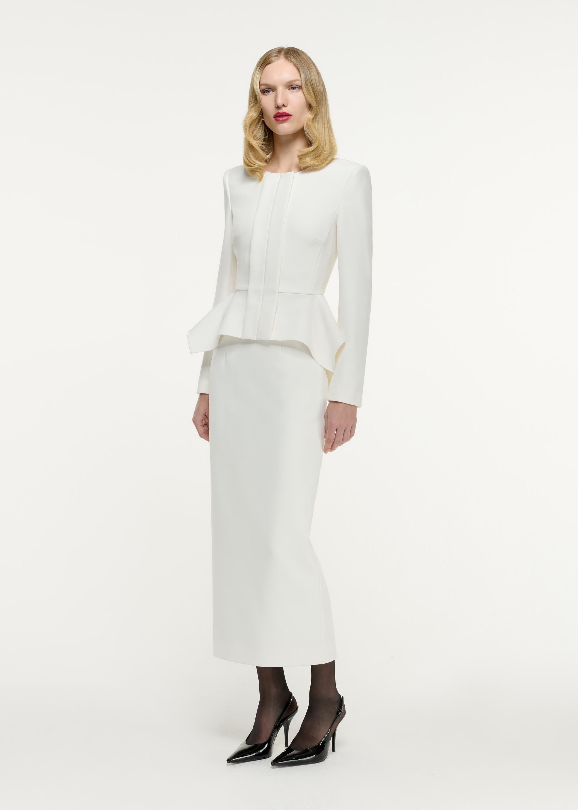 Side view of a model wearing the Crepe Midi Skirt in Cream