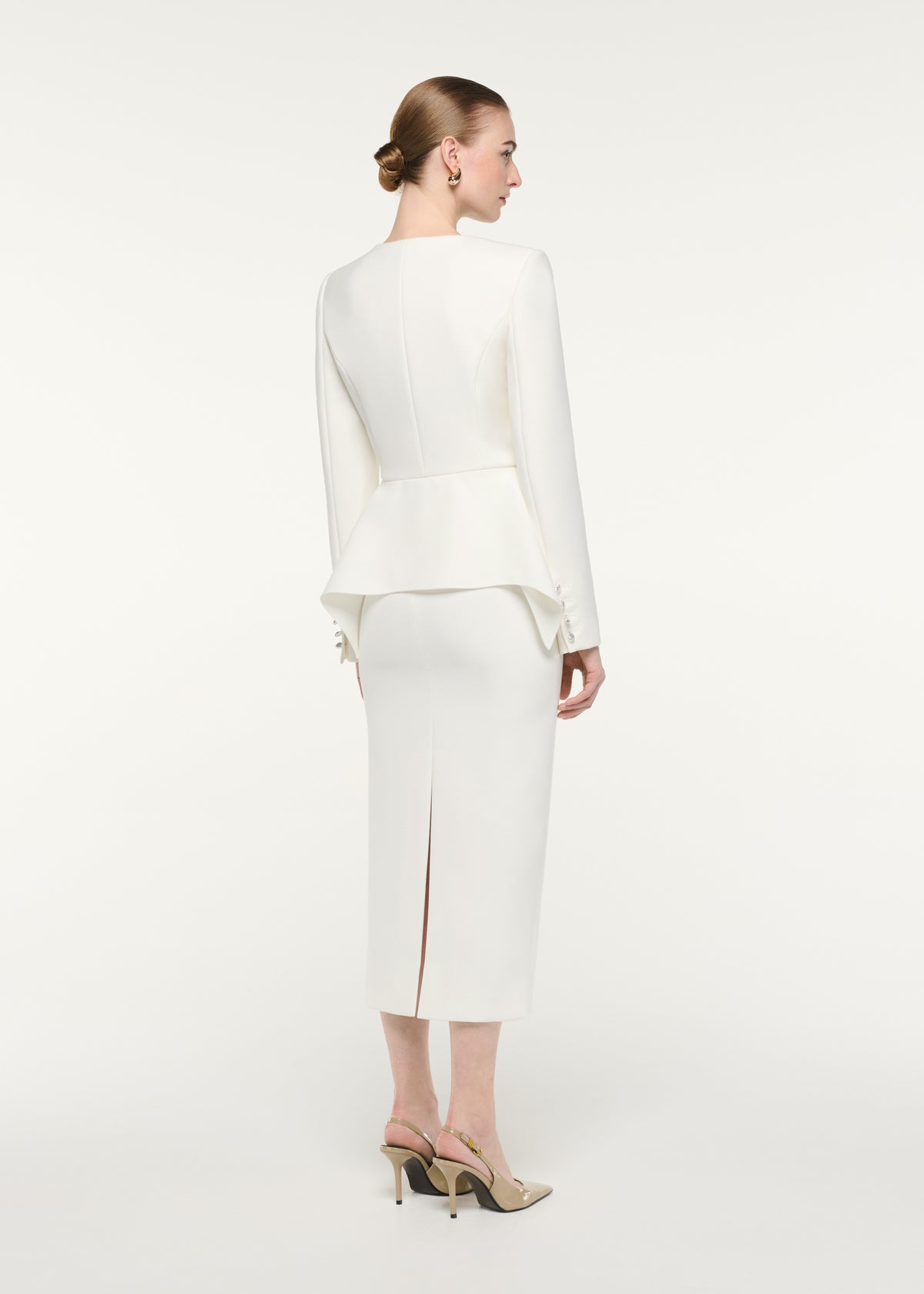 Back view of a model wearing the Crepe Midi Skirt (DNU)