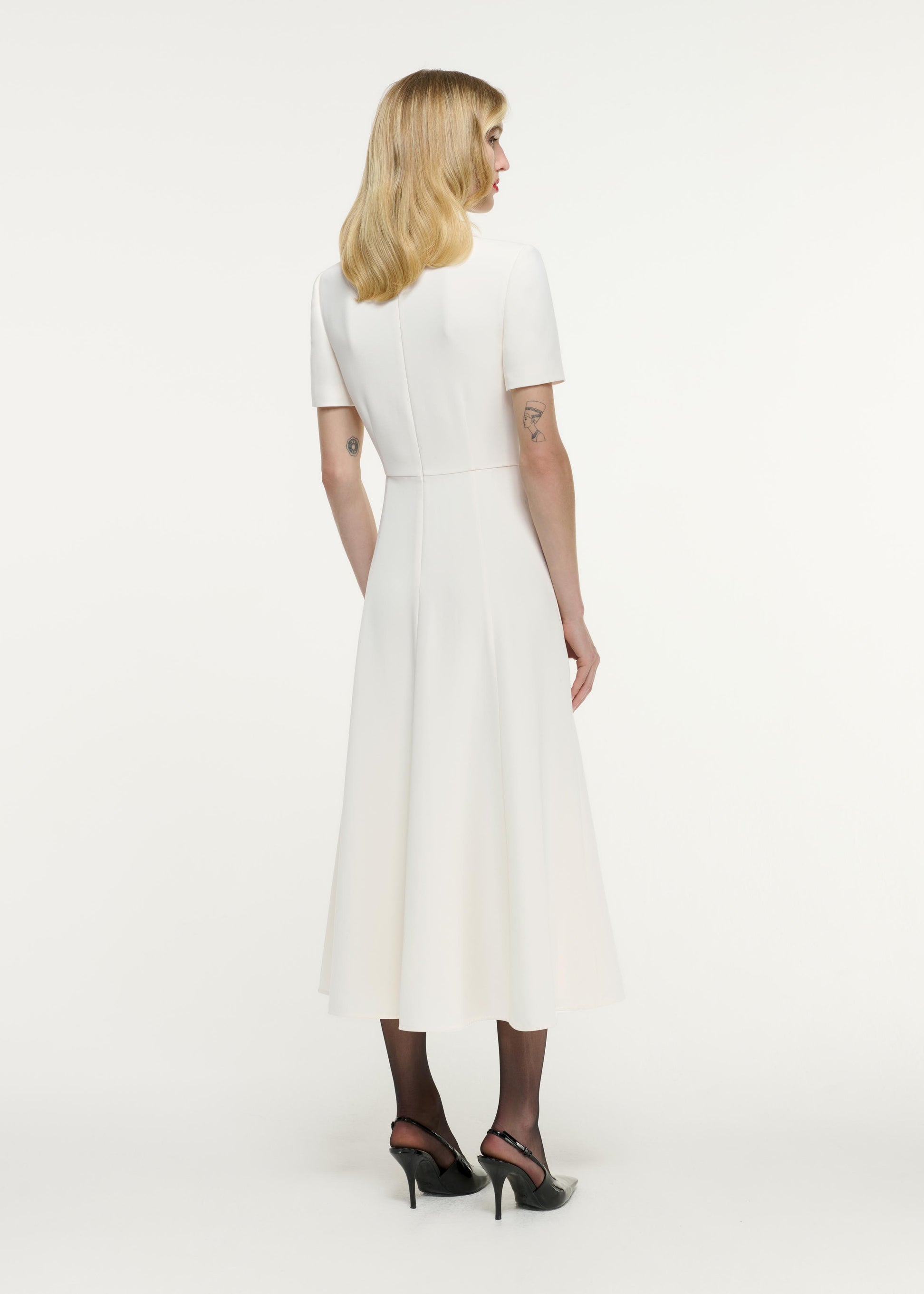 Back view of a model wearing the Short Sleeve Collar Heavy Cady Midi Dress in White