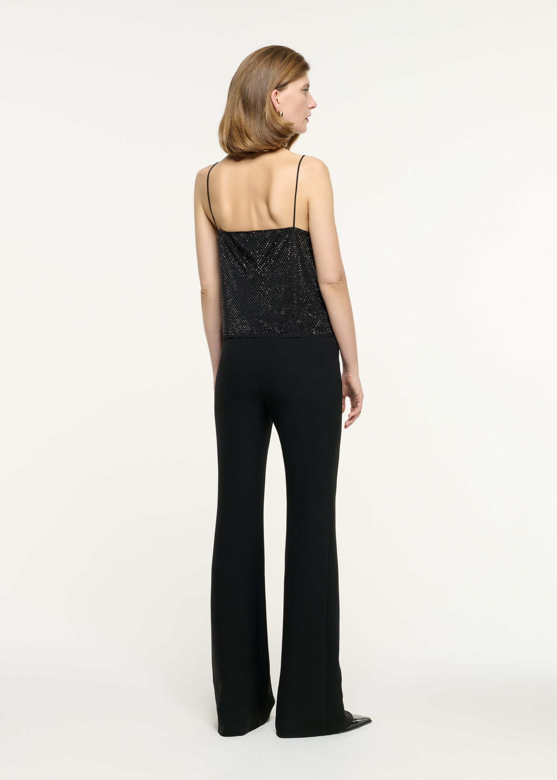 Side view of a model wearing the Diamante Chiffon Top in Black