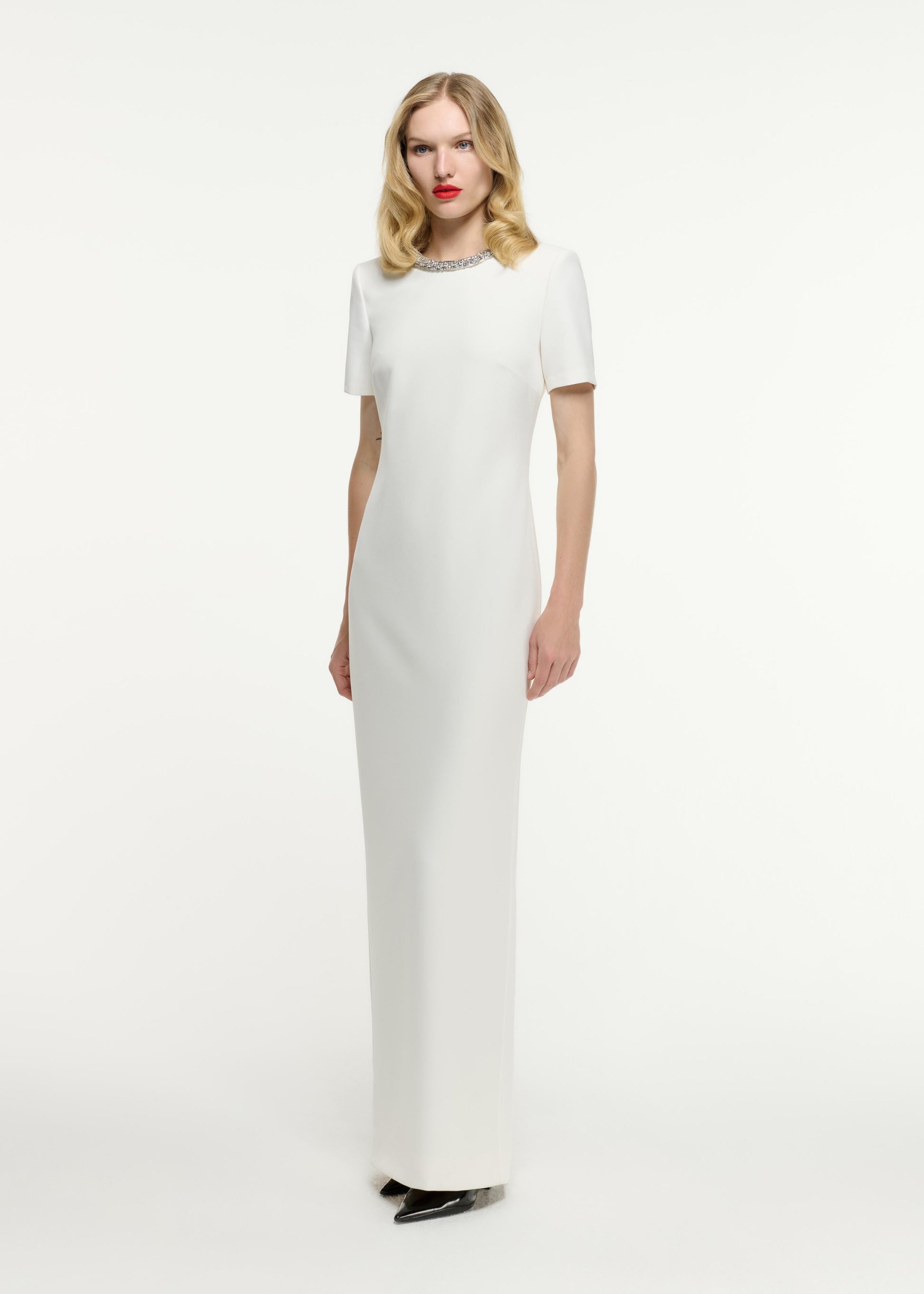 Side view of a model wearing the Short Sleeve Embellished Crepe Maxi Dress in Cream