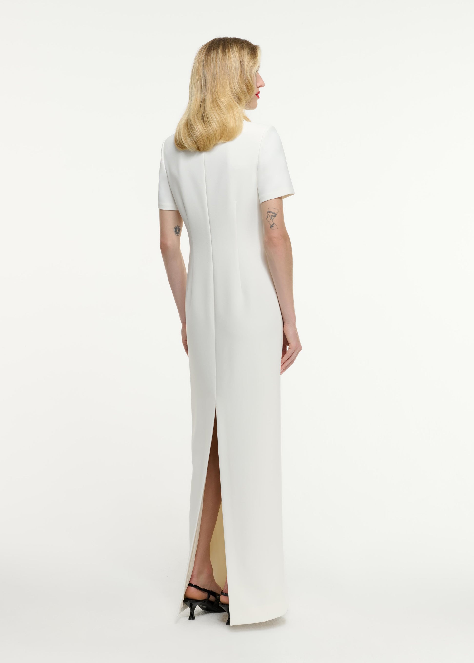 Back view of a model wearing the Short Sleeve Embellished Crepe Maxi Dress in Cream