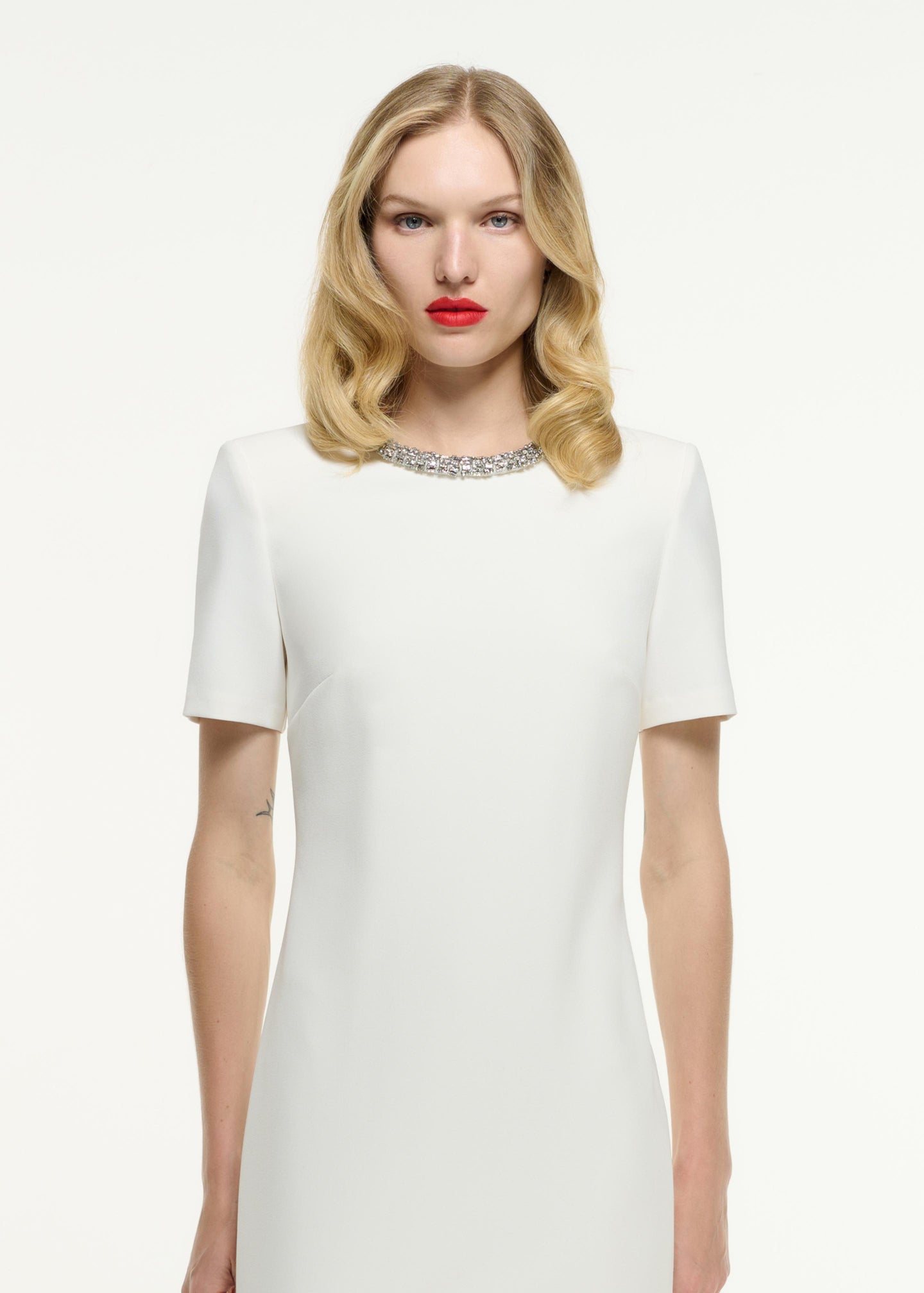 Close up of a model wearing the Short Sleeve Embellished Crepe Maxi Dress in Cream