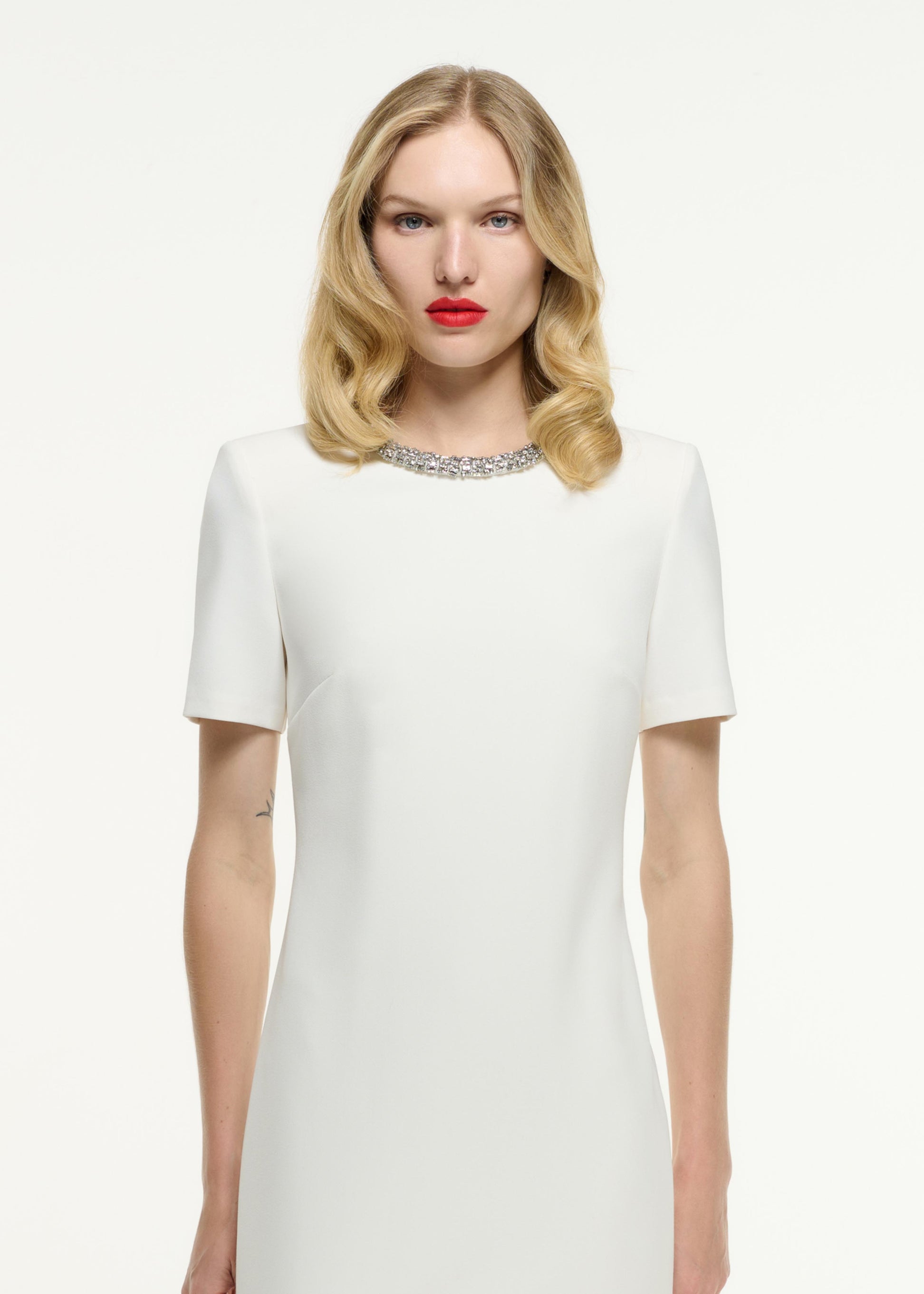 Close up of a model wearing the Short Sleeve Embellished Crepe Maxi Dress in Cream