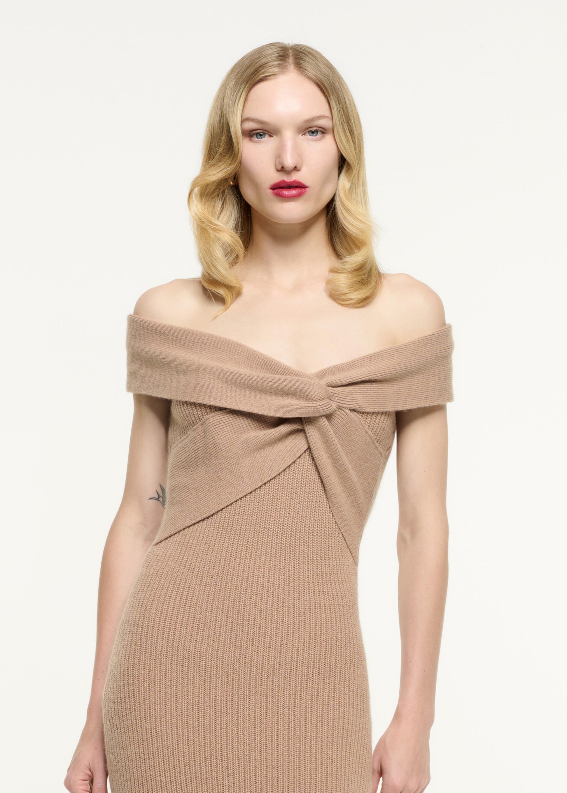 Close up of a model wearing the Off Shoulder Cashmere Midi Dress in Beige