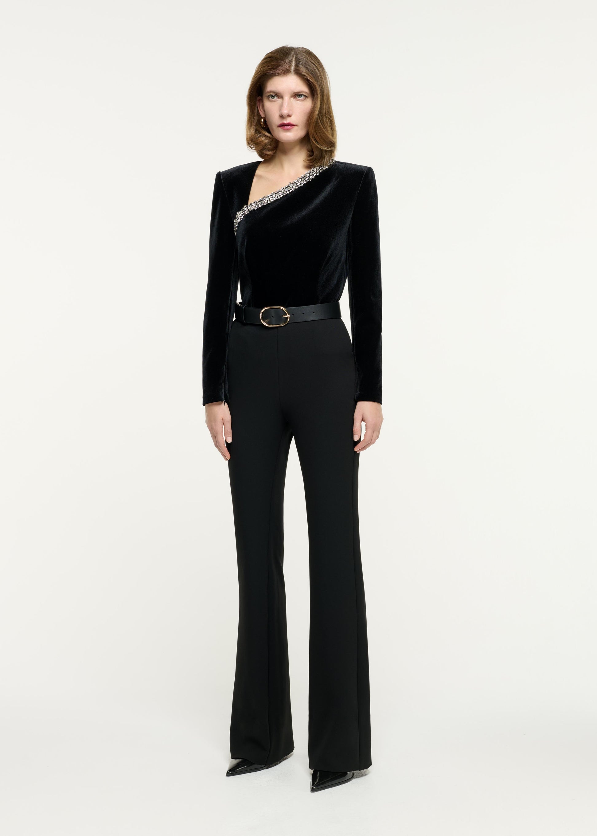 Side view of a model wearing the Velvet Embellished Top in Black