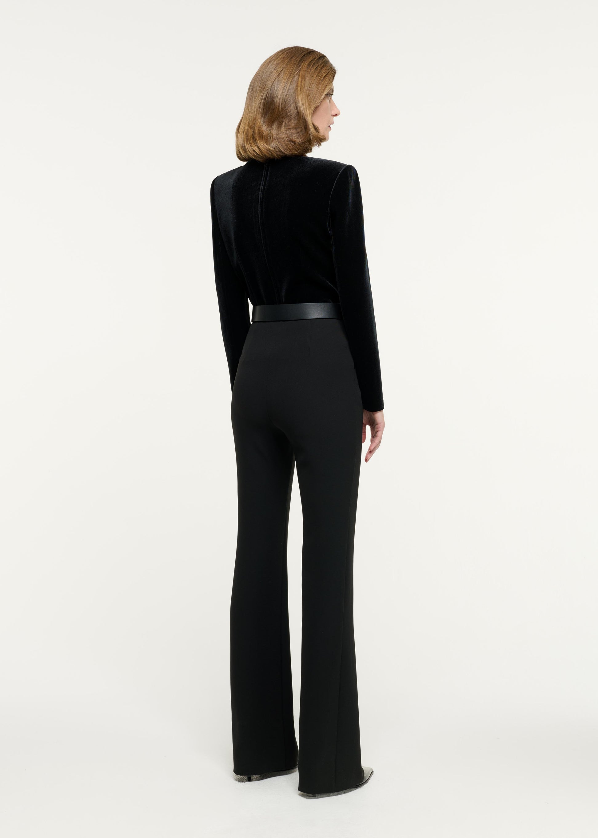 Back view of a model wearing the Velvet Embellished Top in Black