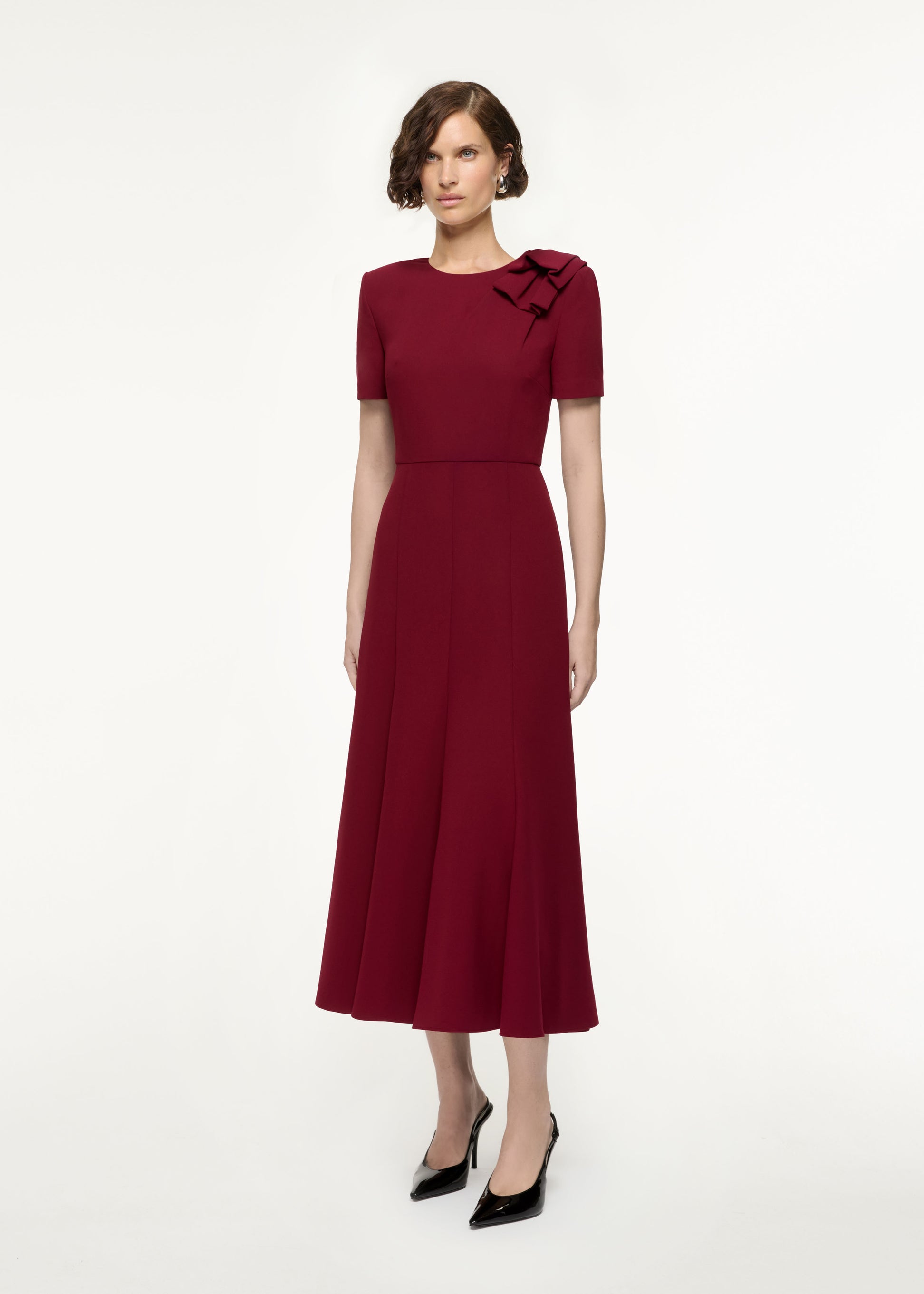 Side view of a model wearing the Short Sleeve Heavy Cady Midi Dress in Red