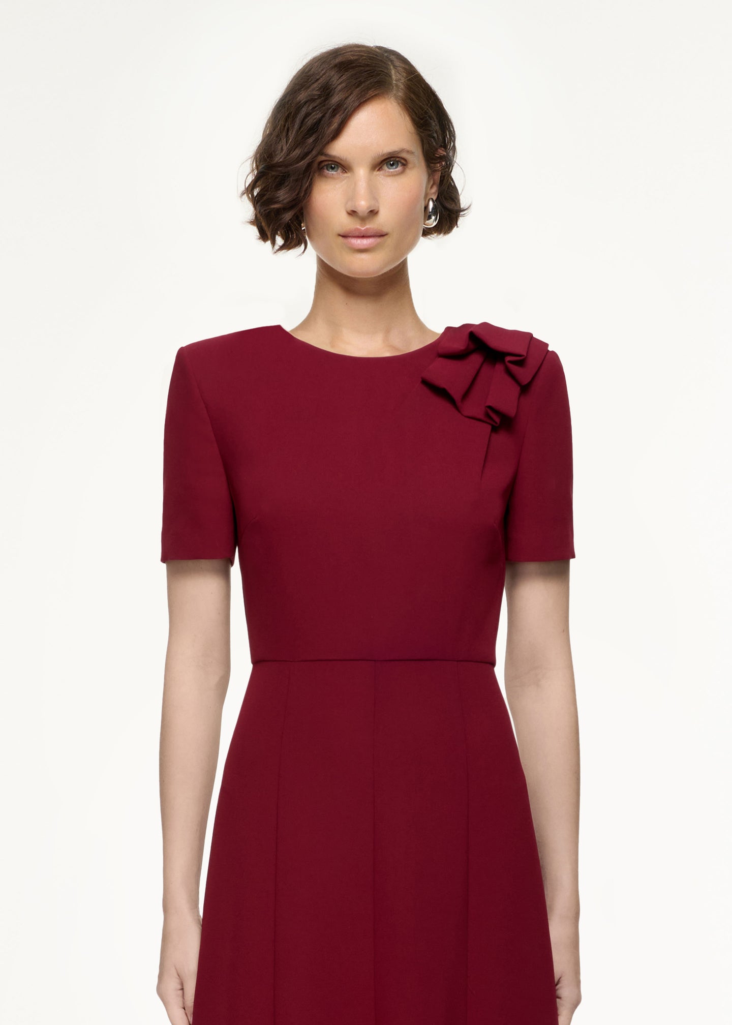 Close up of a model wearing the Short Sleeve Heavy Cady Midi Dress in Red