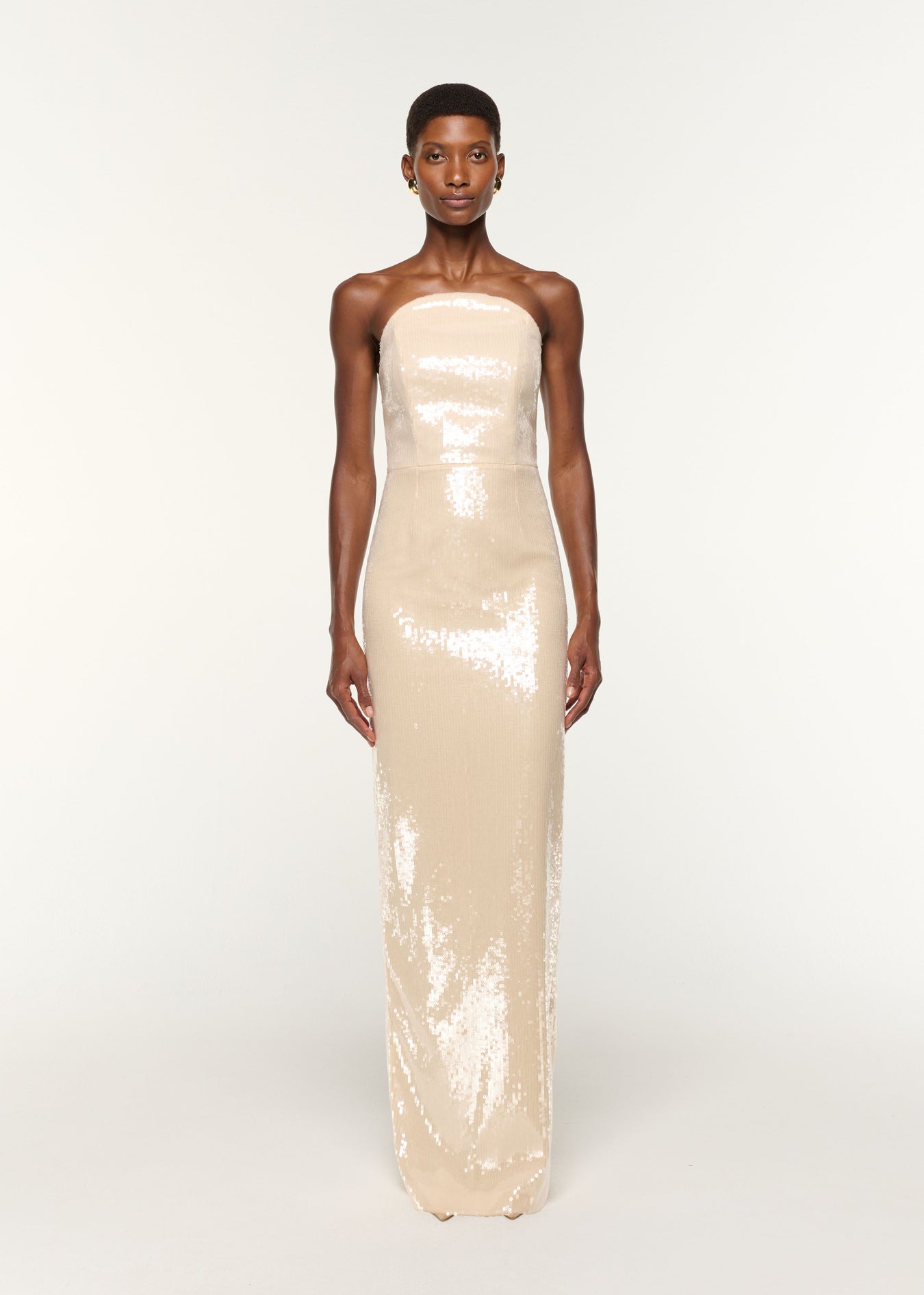 Front view of a model wearing the Curved Neckline Sequin Column Gown in Cream