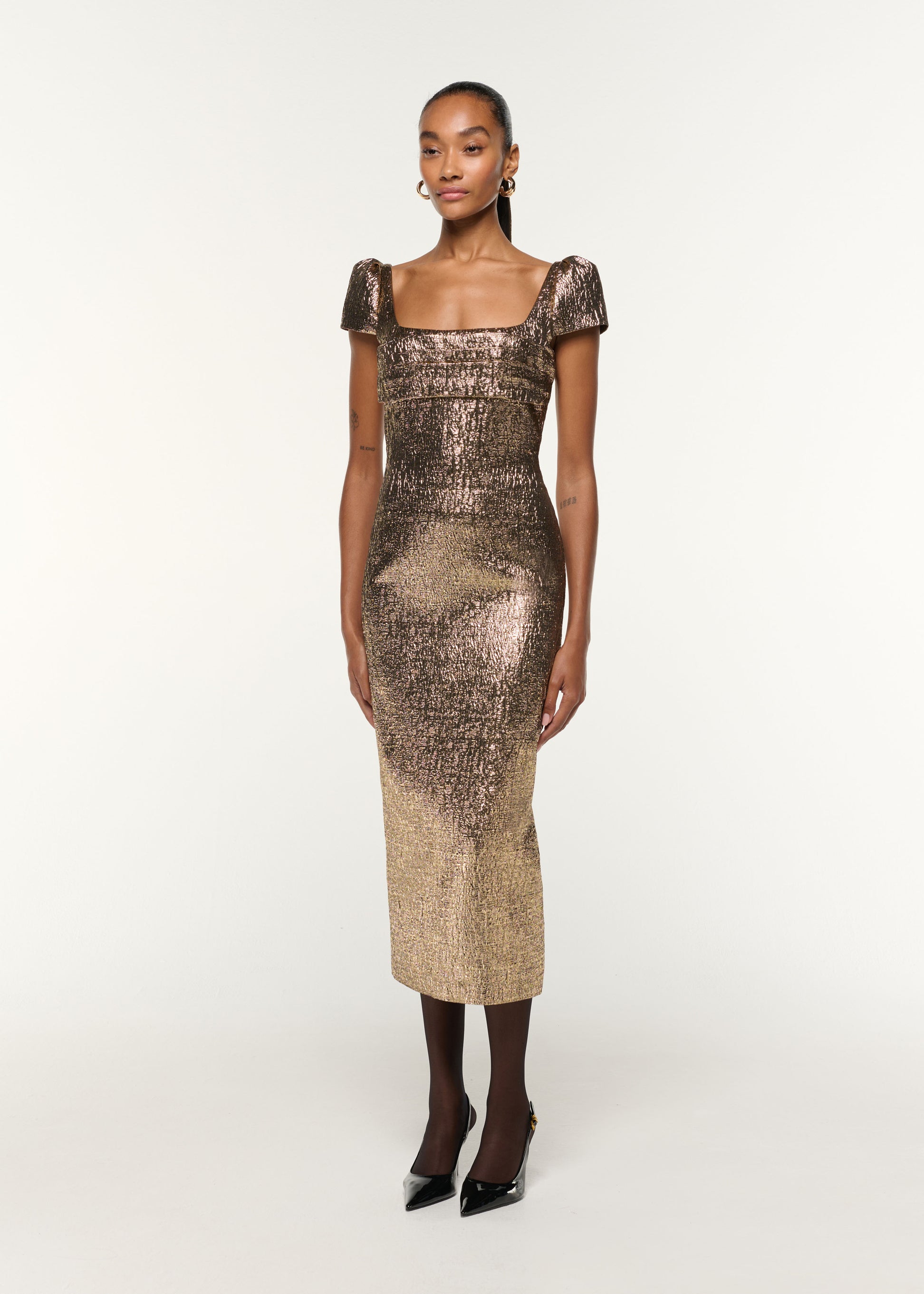 Side view of a model wearing the Pleated Drape Metallic Jacquard Dress in Gold