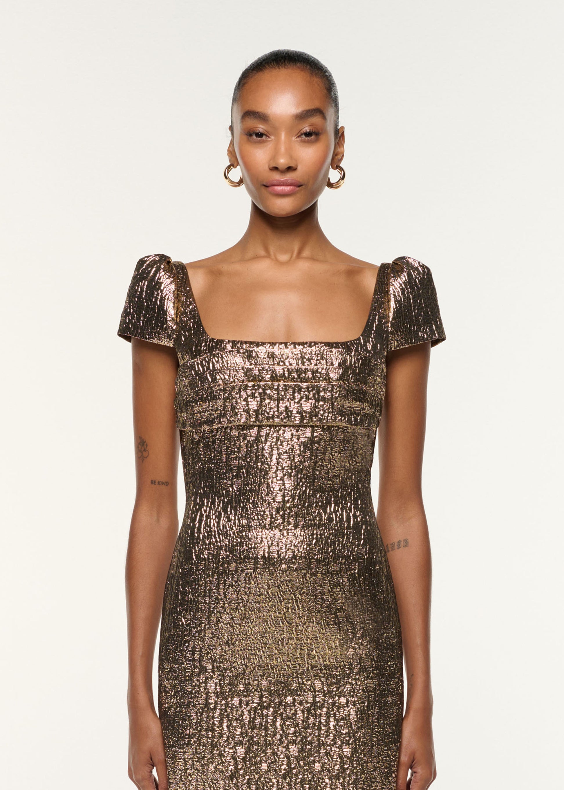Close up of a model wearing the Pleated Drape Metallic Jacquard Dress in Gold