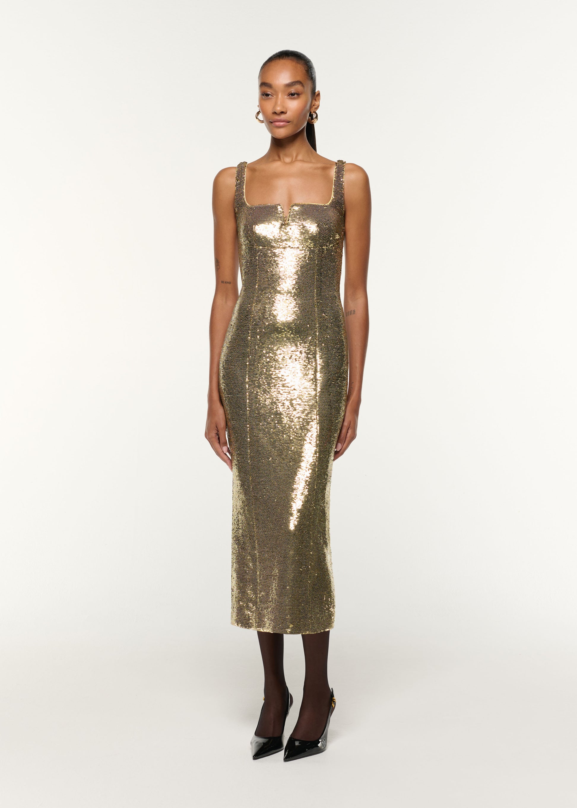 Side view of a model wearing the Square Neckline Sequin Dress in Gold