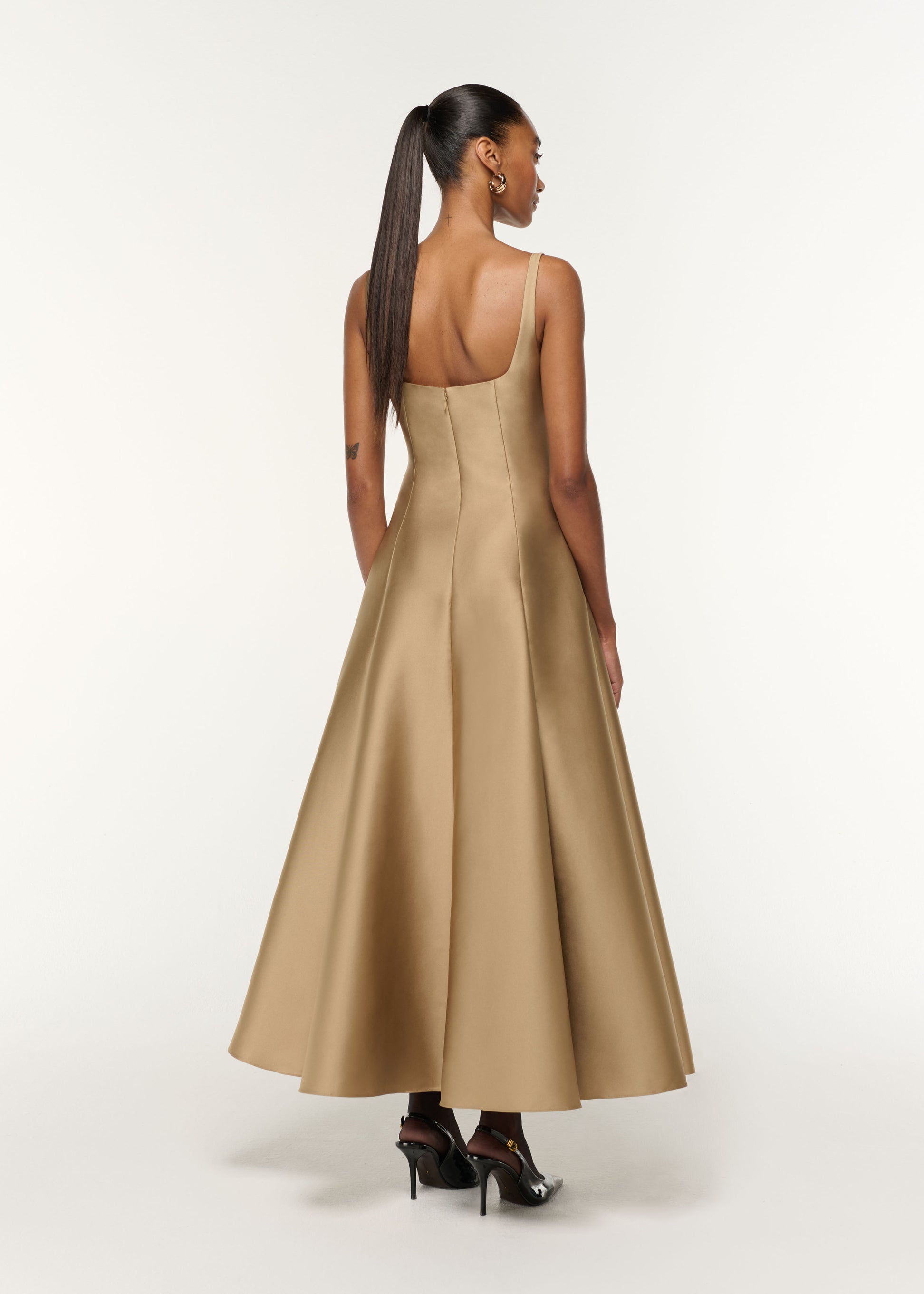 Back view of a model wearing the Square Neckline Taffeta Dress in Gold