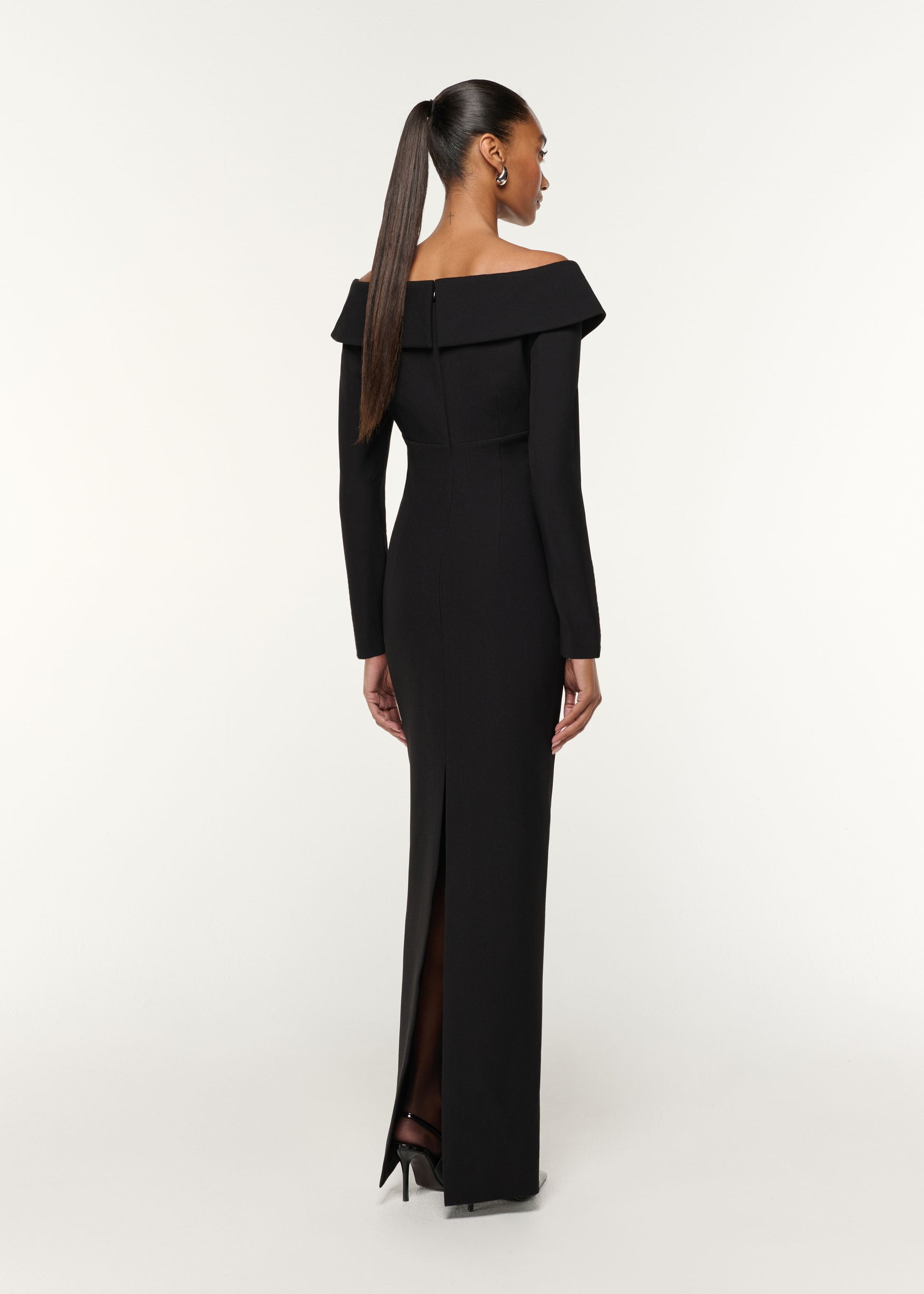 Back view of a model wearing the Lace Insert Crepe Column Gown in Black