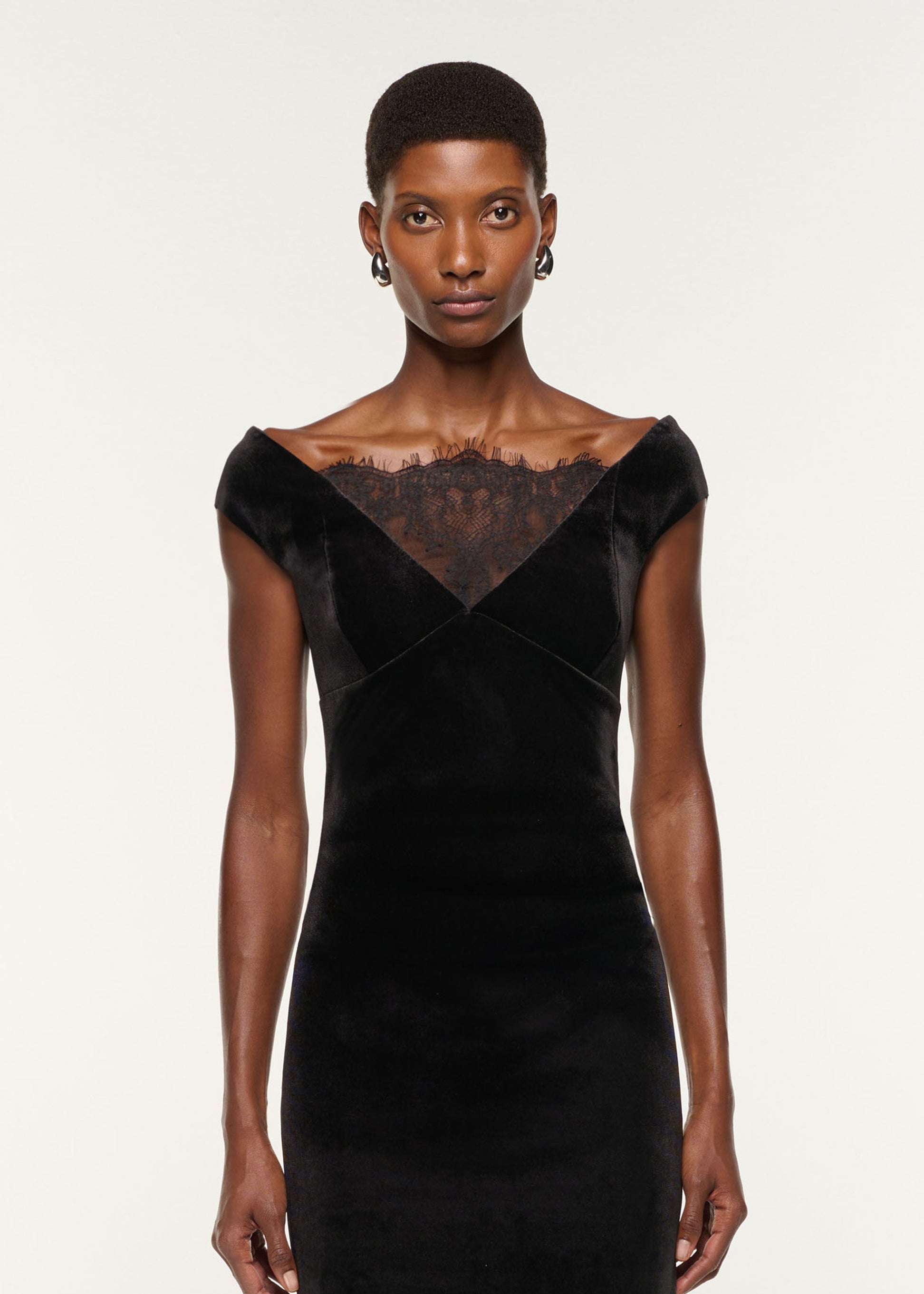 Close up of a model wearing the Lace Insert Scuba Velvet Dress in Black