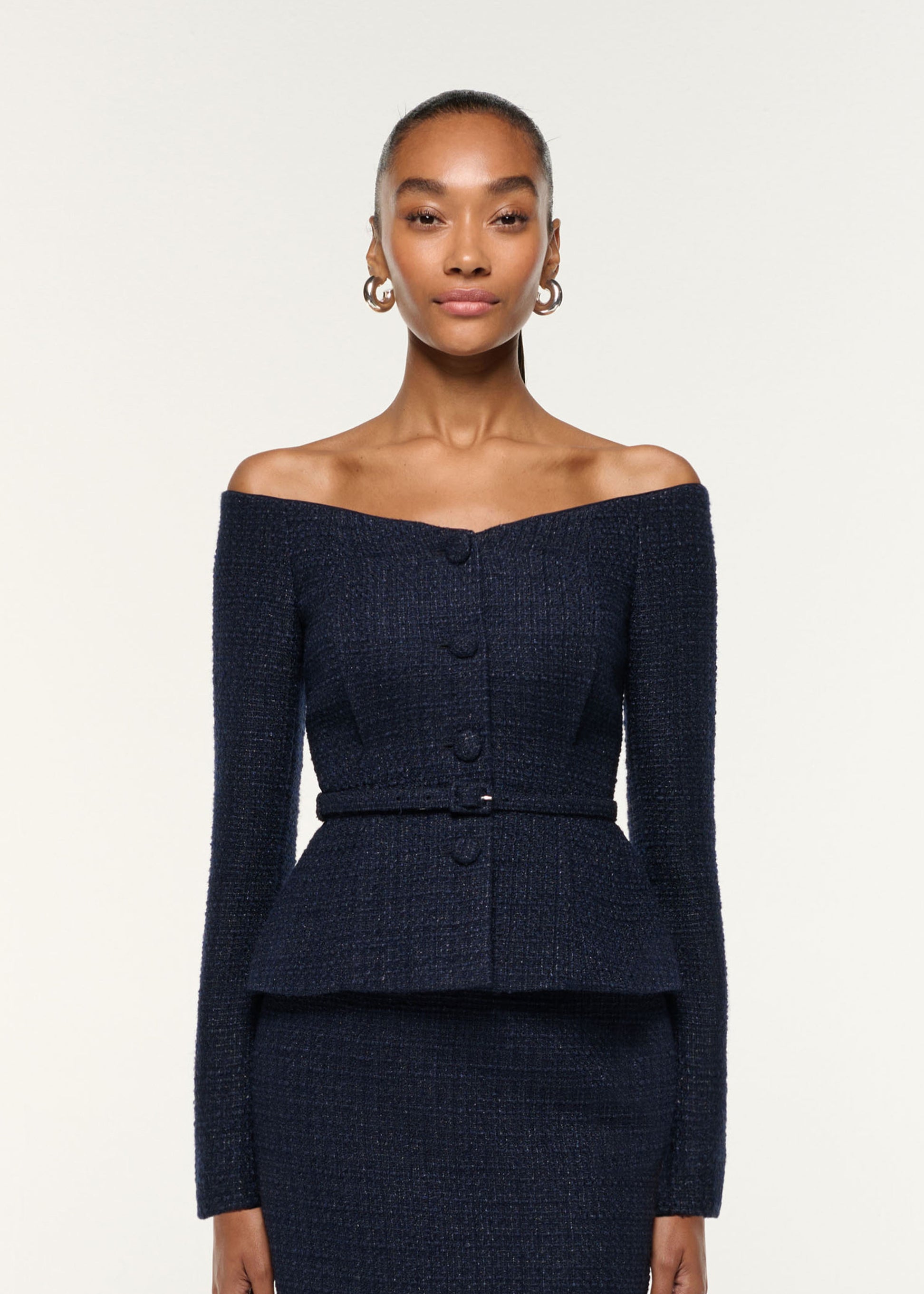 Close up of a model wearing the Off The Shoulder Boucle Top in Navy