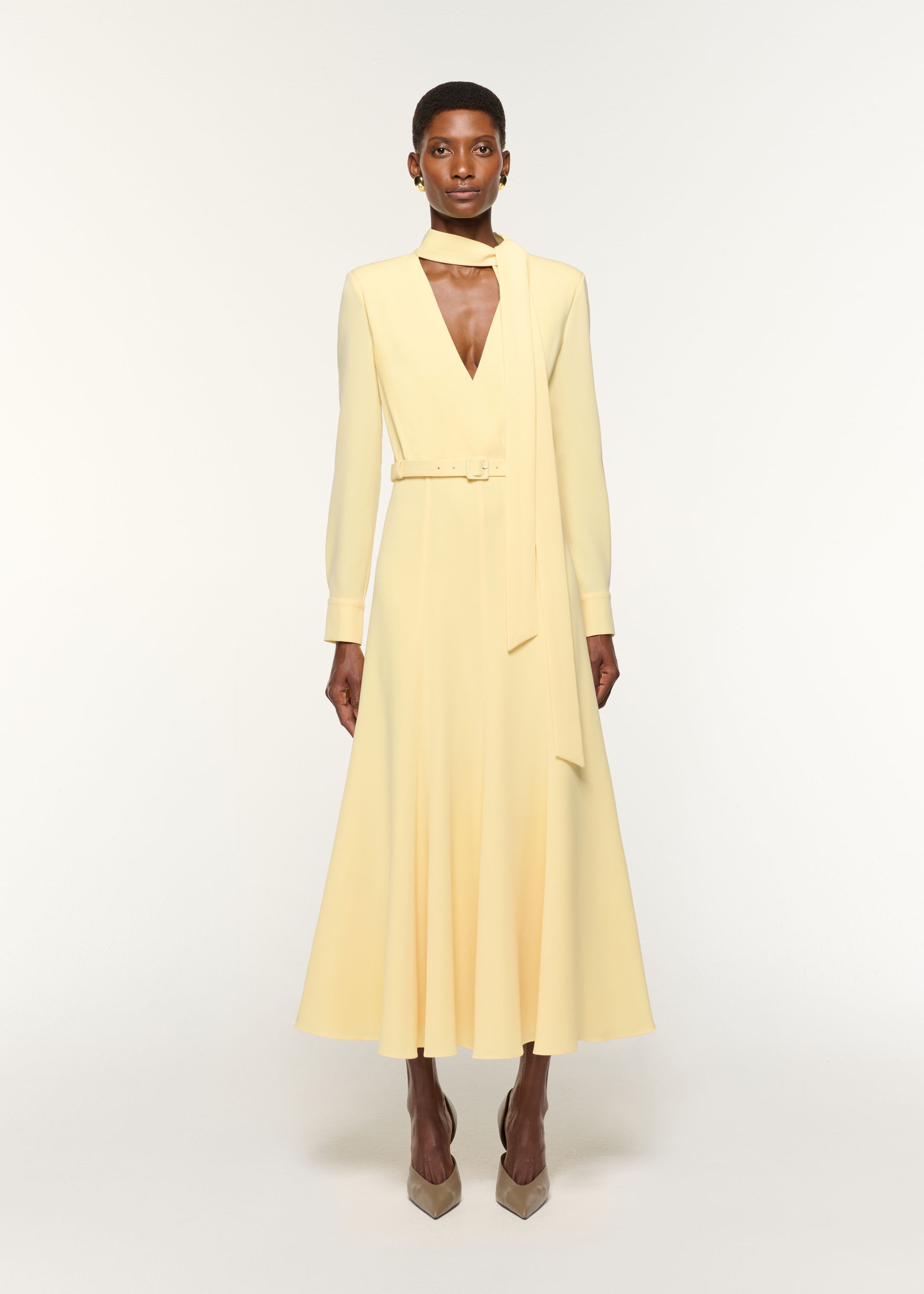 Front view of a model wearing the Light Cady Cut Out Dress in Yellow