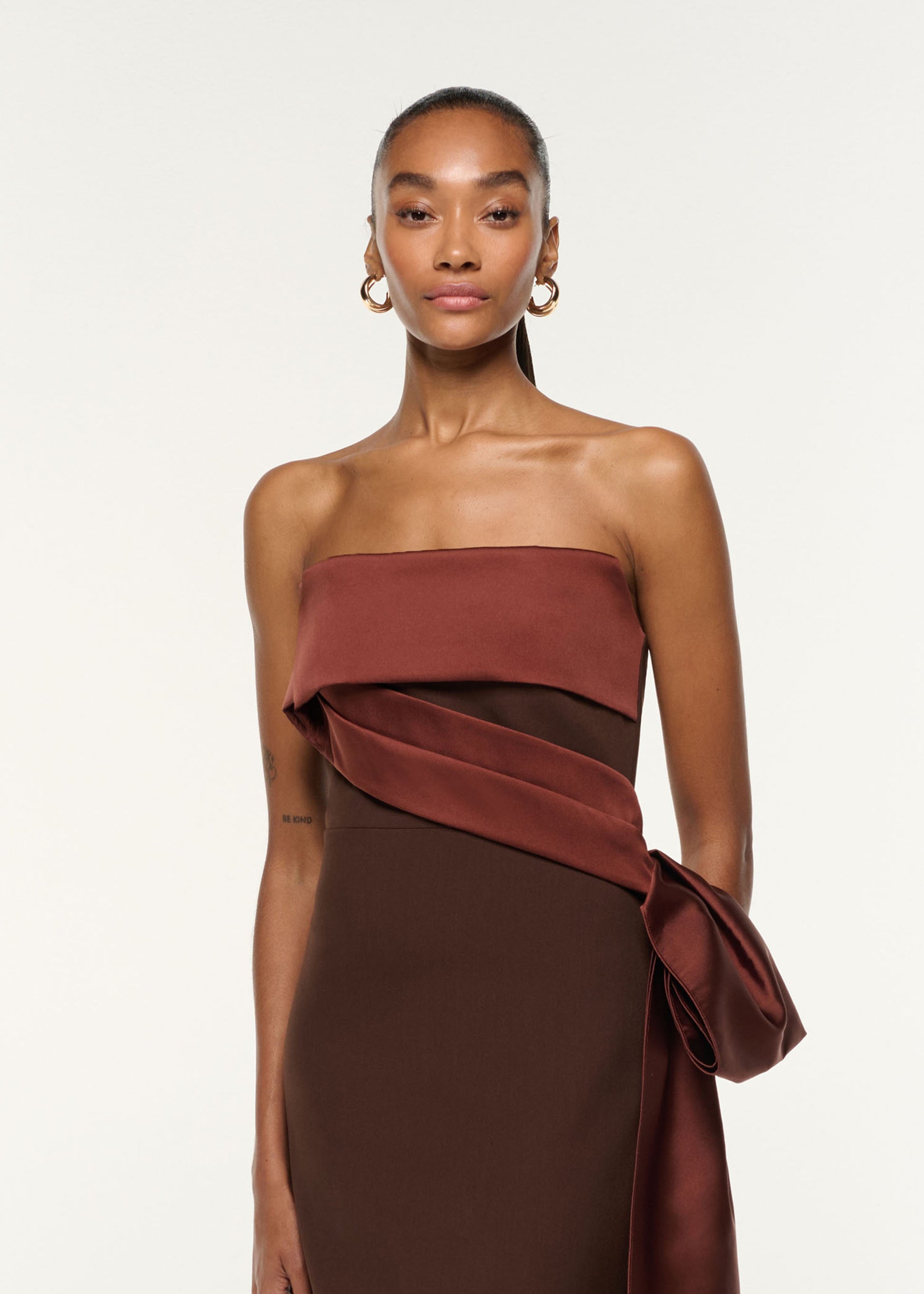Close up of a model wearing the Contrast Drape Taffeta And Stretch Crepe Gown in Brown