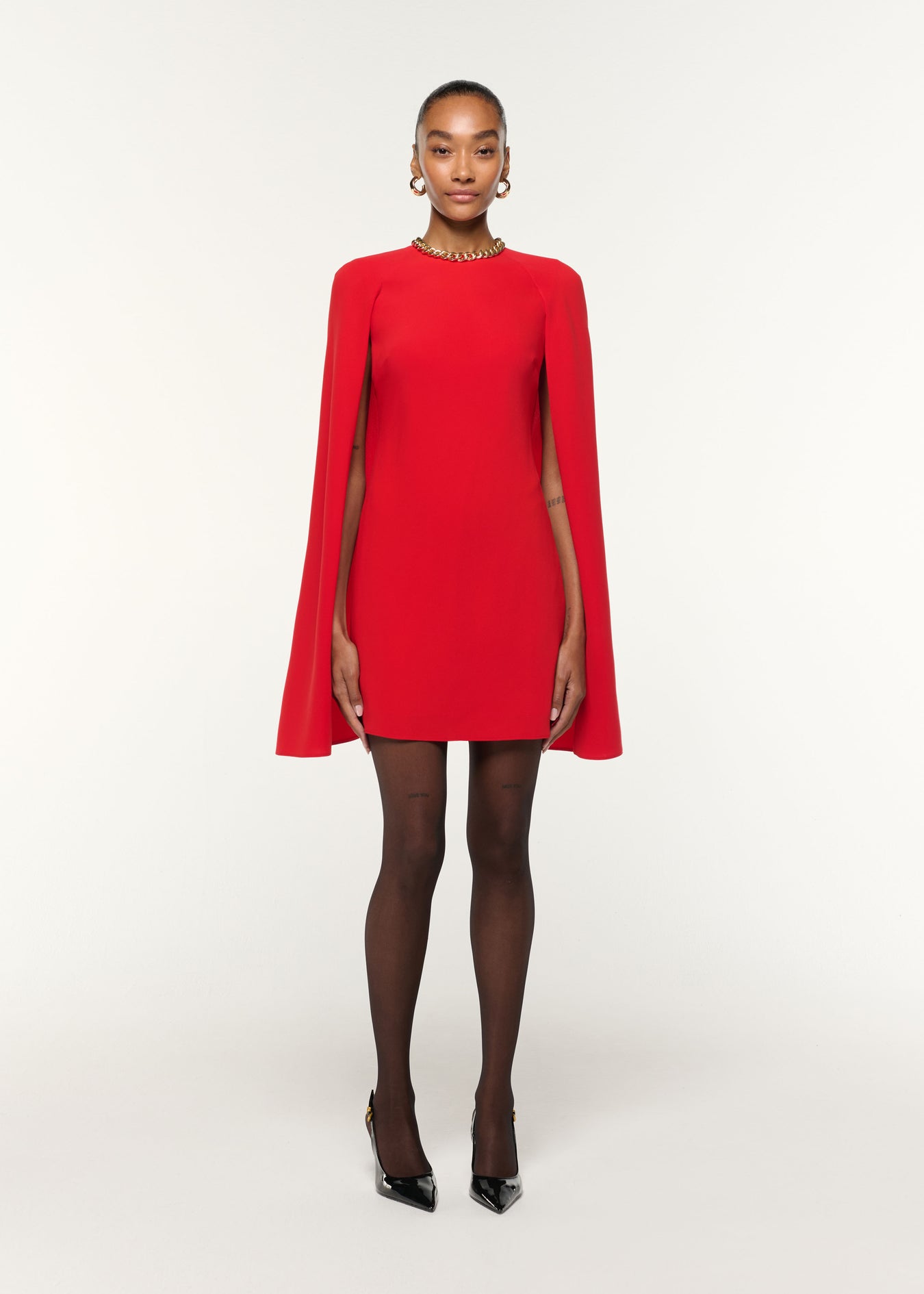 Front view of a model wearing the Light Cady Cape Dress in Red