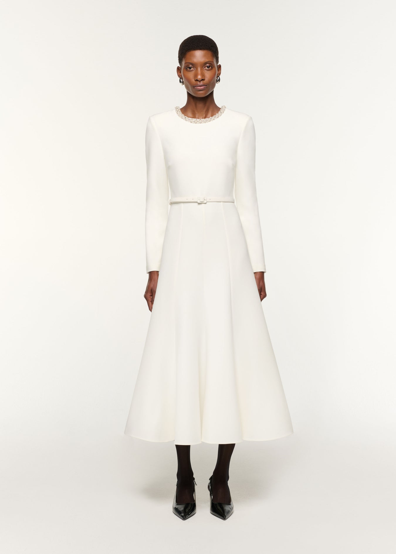 Front view of a model wearing the Crystal Neckline Crepe Dress in White