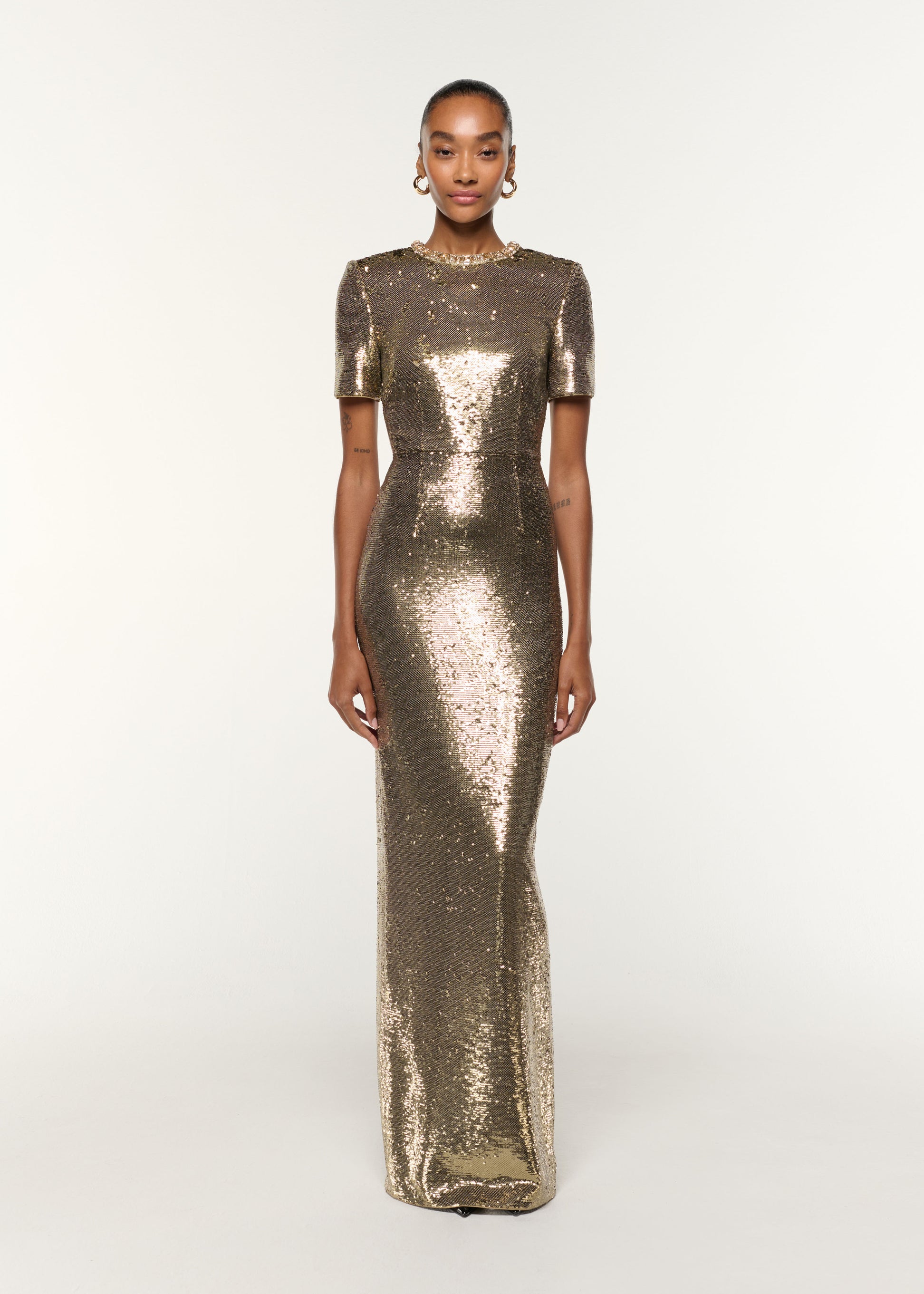 Front view of a model wearing the Crystal Neckline Sequin Column Gown in Gold