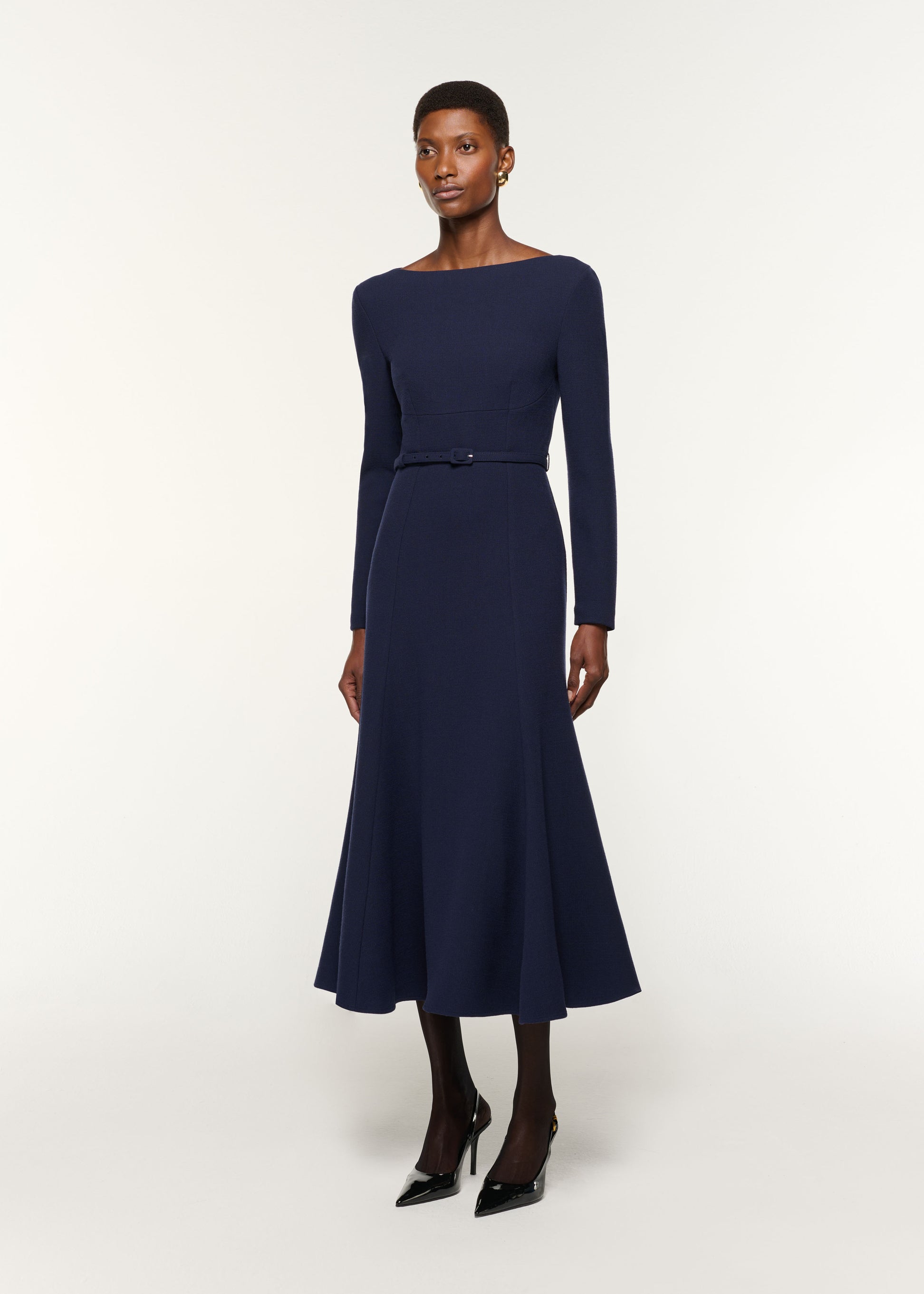 Side view of a model wearing the Boat Neck Wool Crepe Dress in Navy