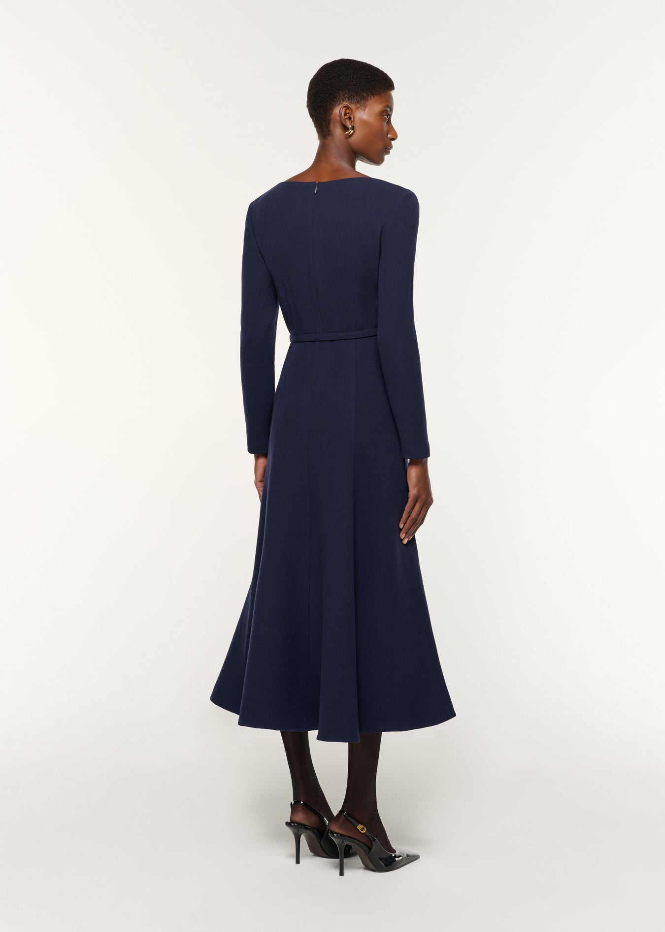 Back view of a model wearing the Boat Neck Wool Crepe Dress in Navy