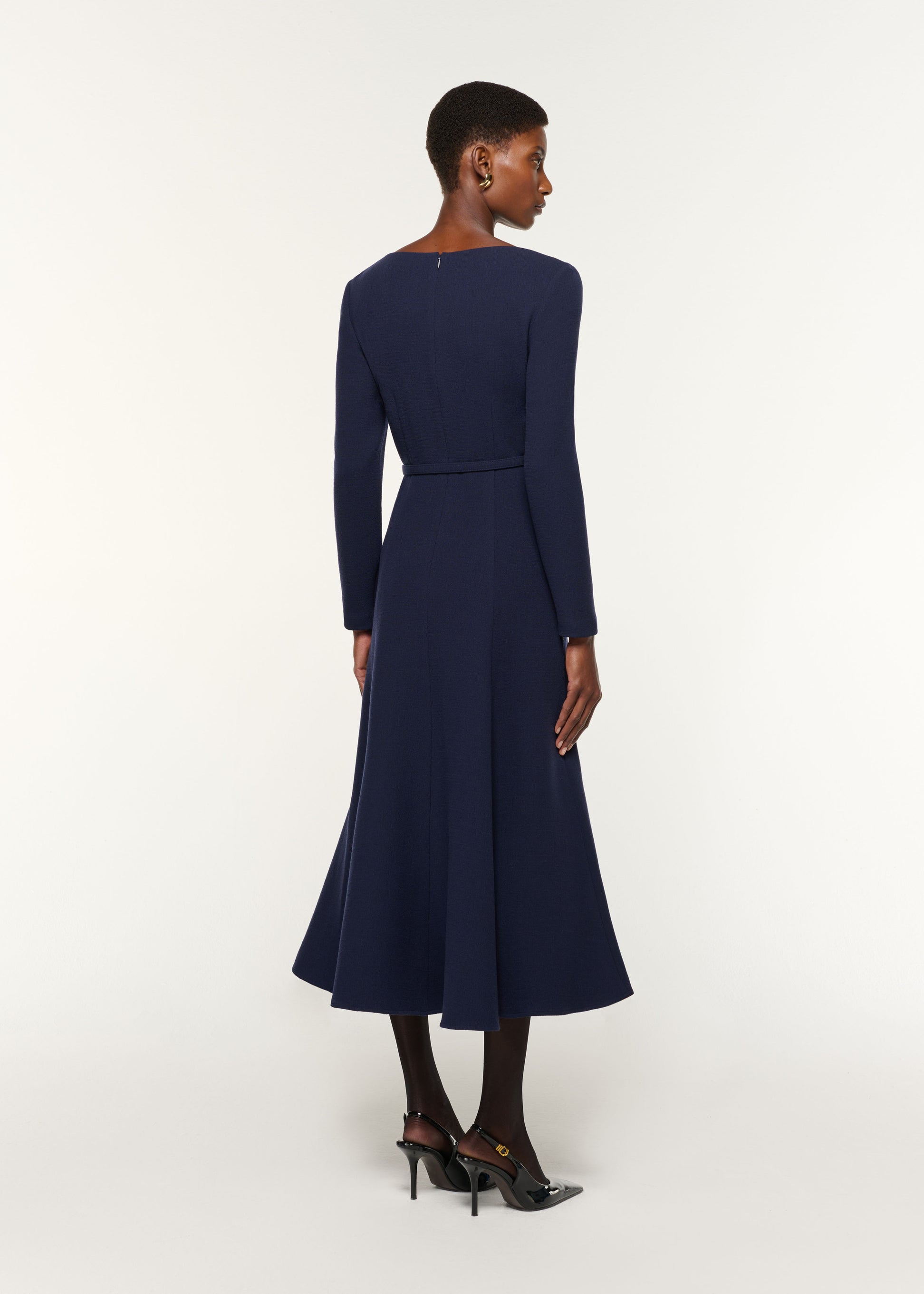 Back view of a model wearing the Boat Neck Wool Crepe Dress in Navy