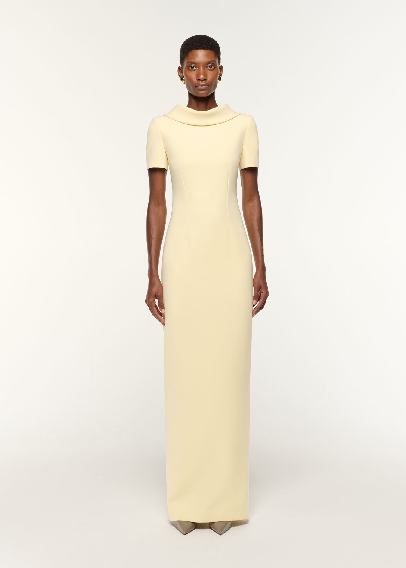 Front view of a model wearing the Collared Crepe Gown in Yellow