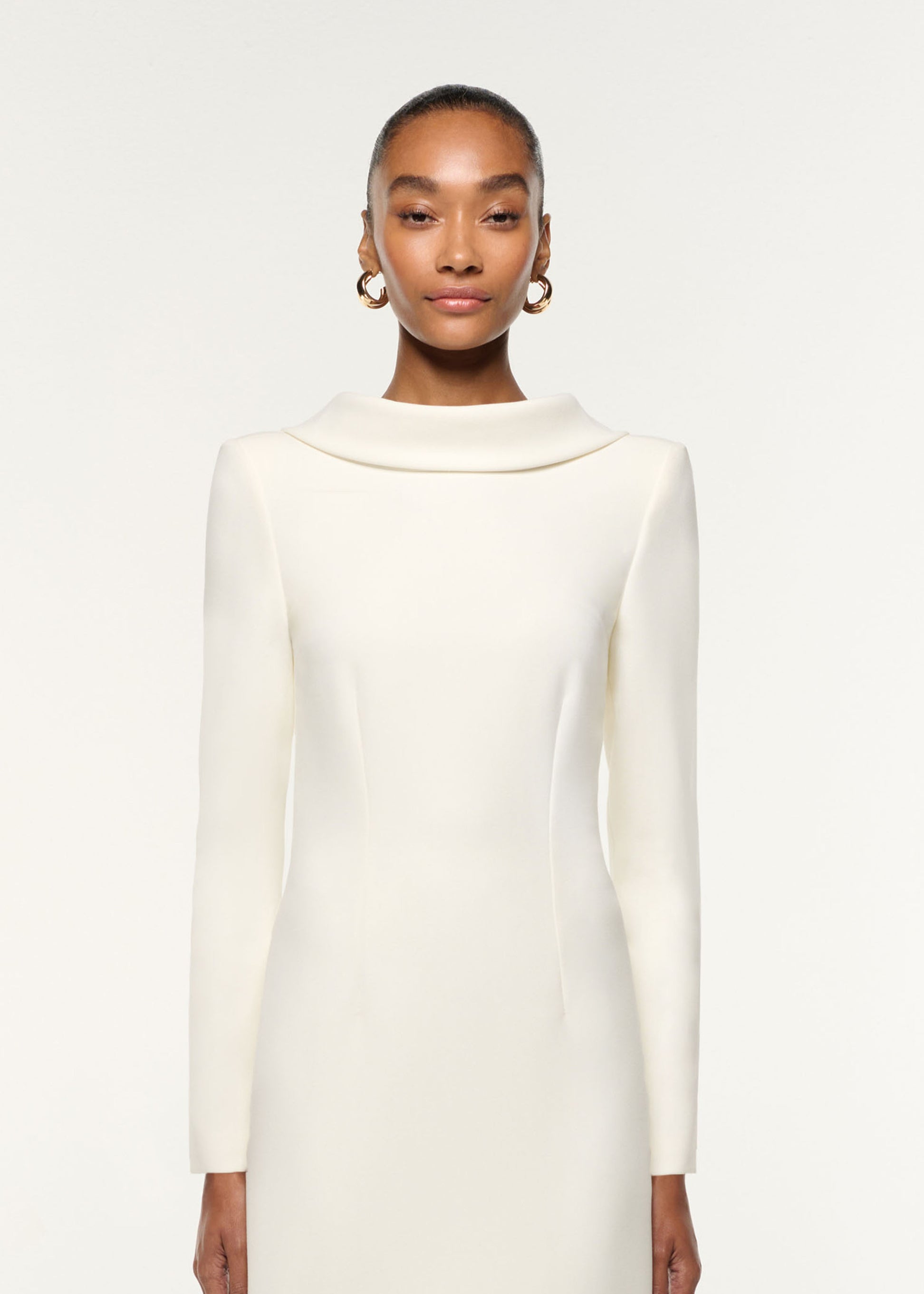 Close up of a model wearing the Collared Crepe Mini Dress in Cream