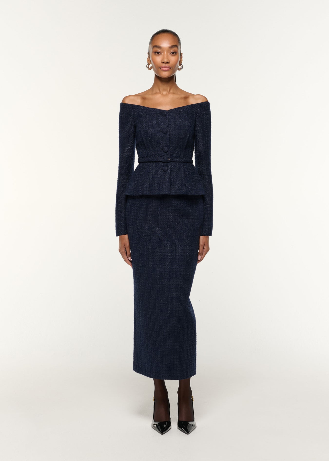 Front view of a model wearing the Boucle Column Skirt in Navy