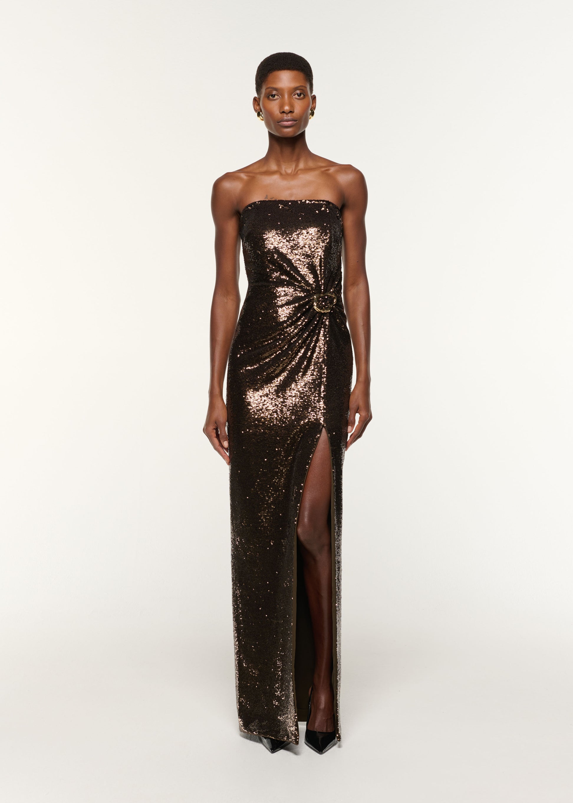 Front view of a model wearing the Strapless Sequin Buckle Gown in Bronze