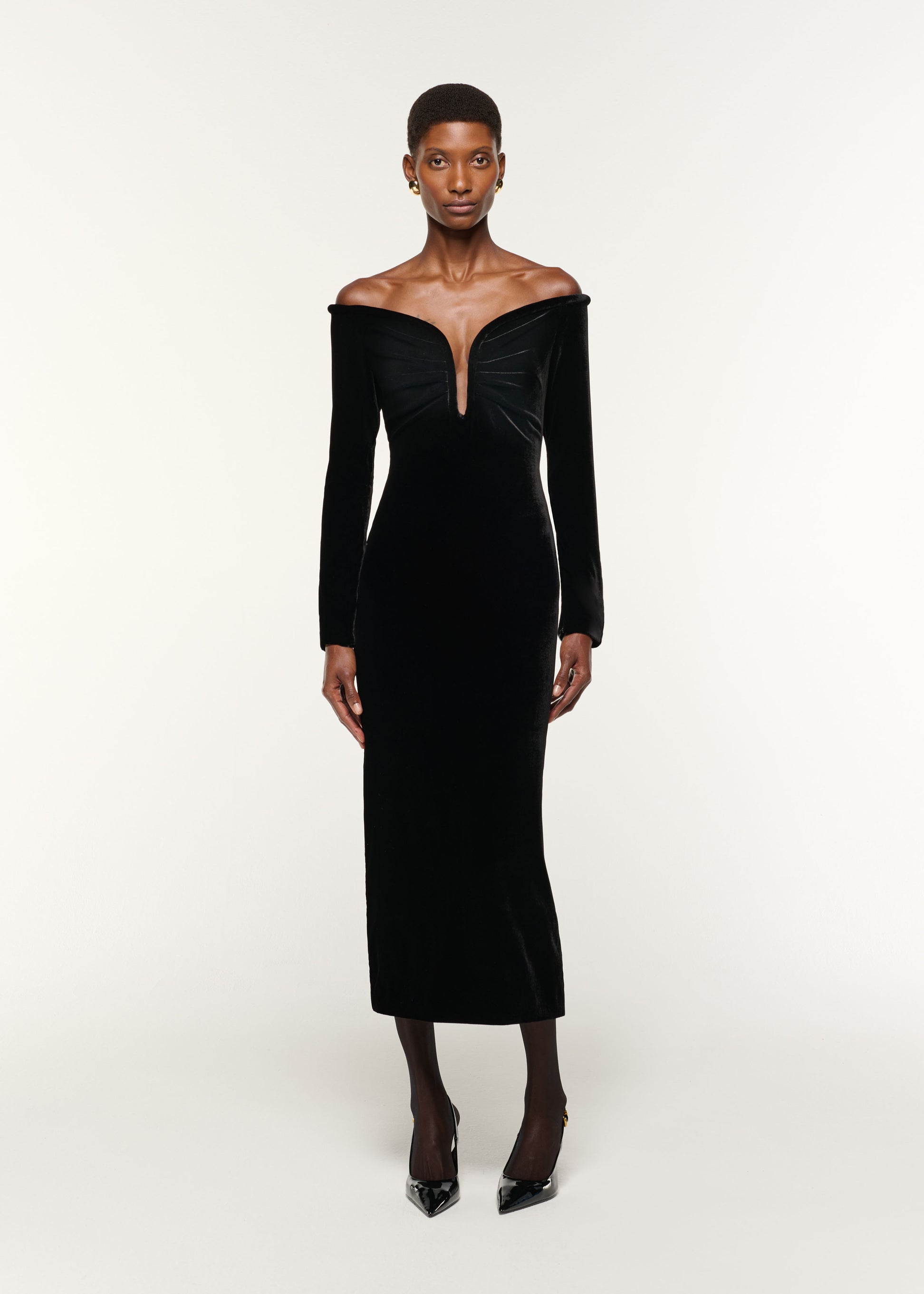 Front view of a model wearing the Plunge Neck Velvet Midi Dress in Black