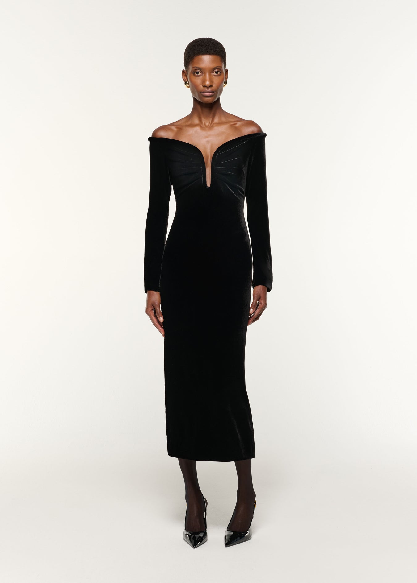 Front view of a model wearing the Plunge Neck Velvet Midi Dress in Black