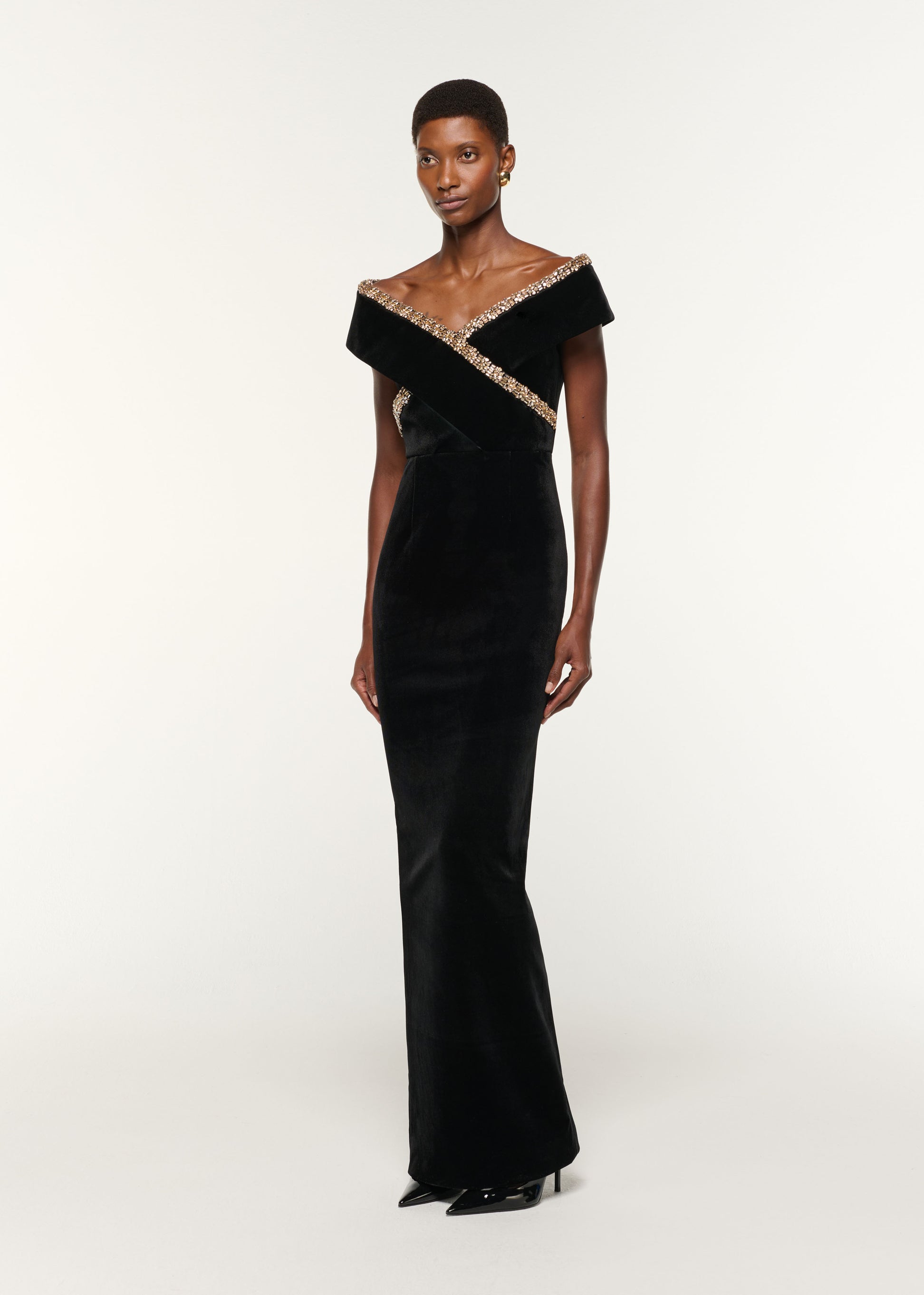 Side view of a model wearing the Velvet Diamante Crossover Gown in Black