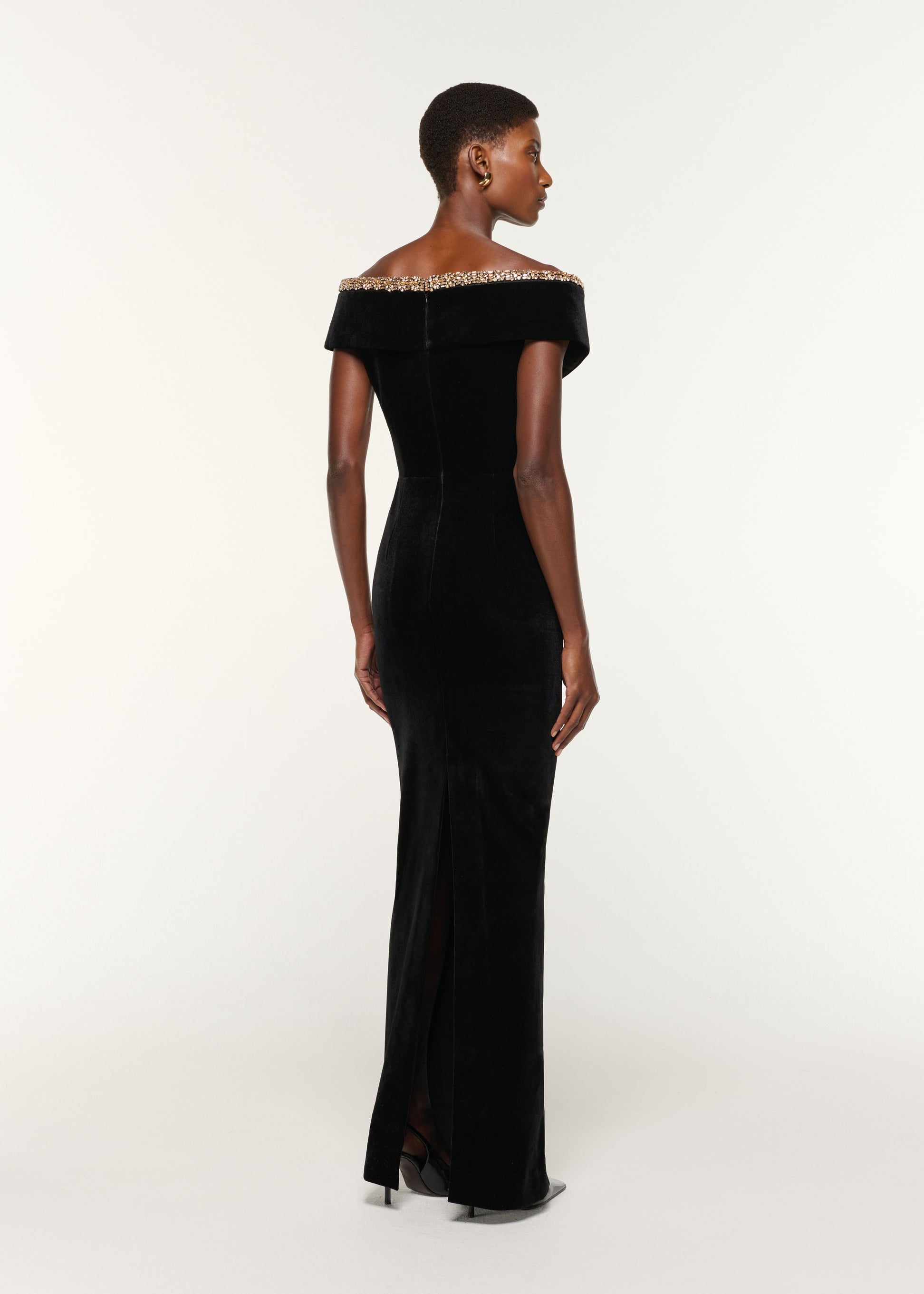 Back view of a model wearing the Velvet Diamante Crossover Gown in Black
