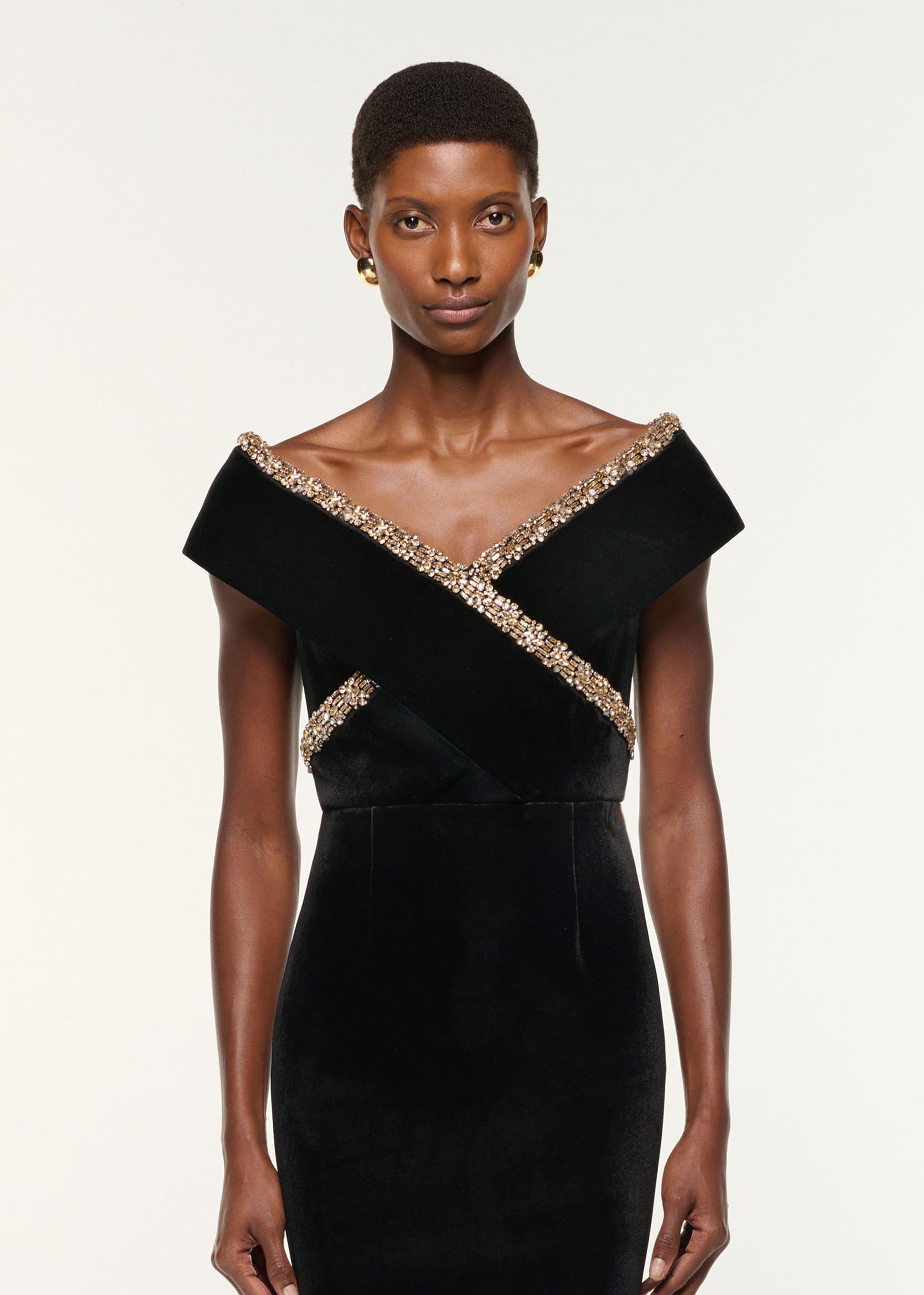 Close up of a model wearing the Velvet Diamante Crossover Gown in Black