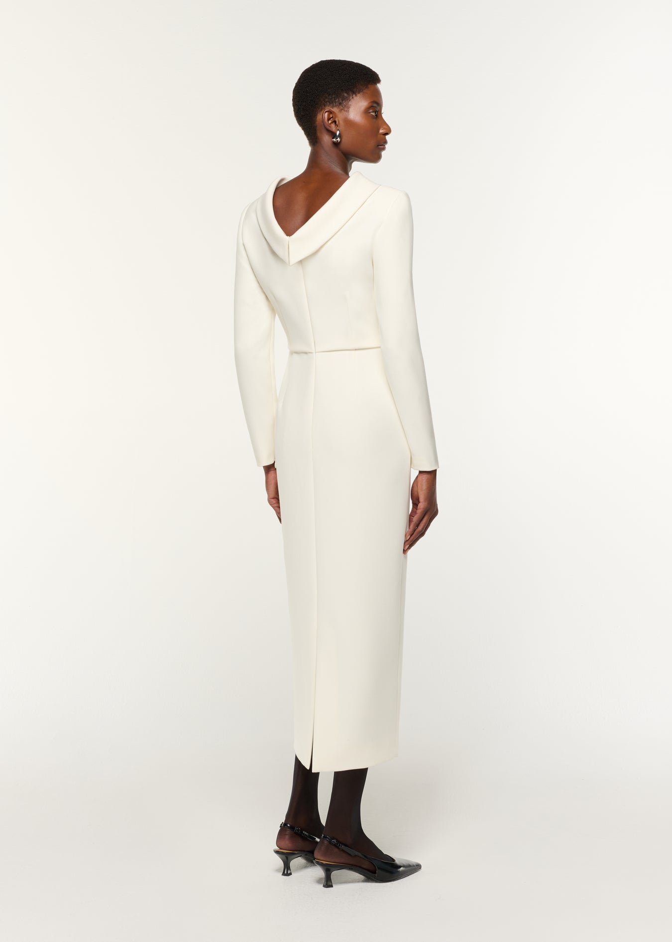 Back view of a model wearing the Collared Crepe Midi Dress in Cream